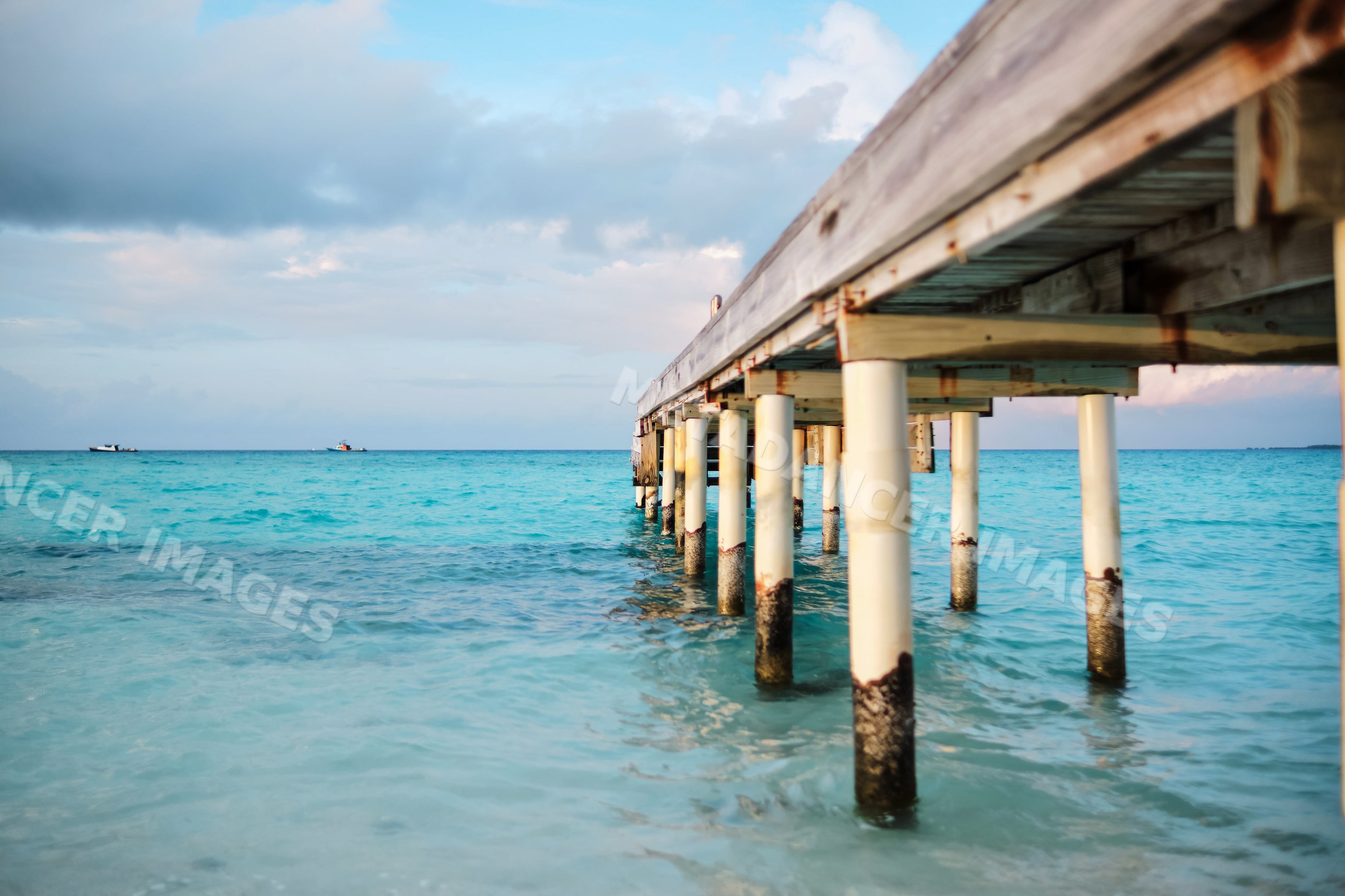 Wooden pier extending over turquoise ocean water