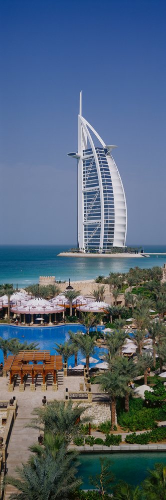 Burj al arab hotel on an island near dubai coastline with a resort