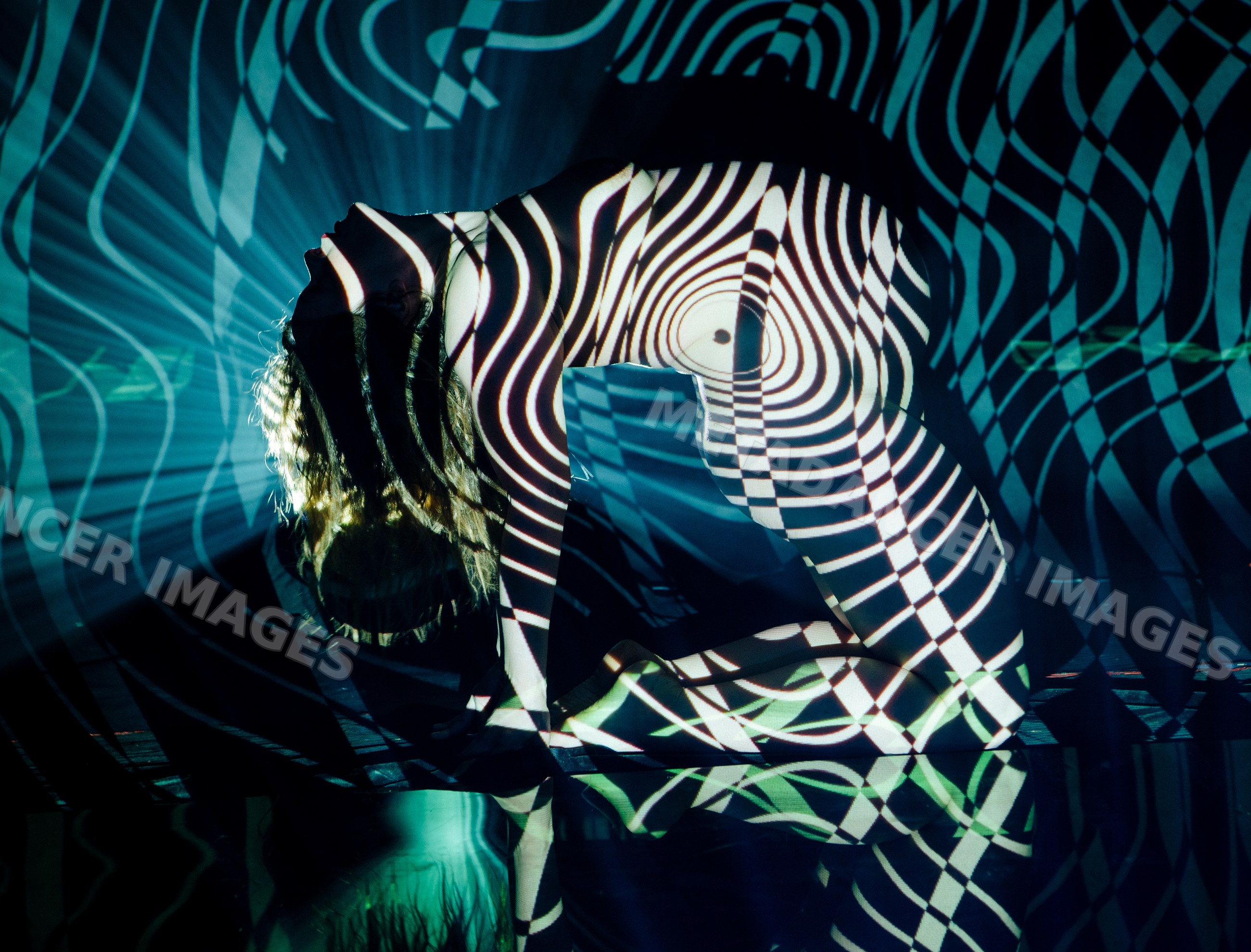 White woman posing with abstract striped projection
