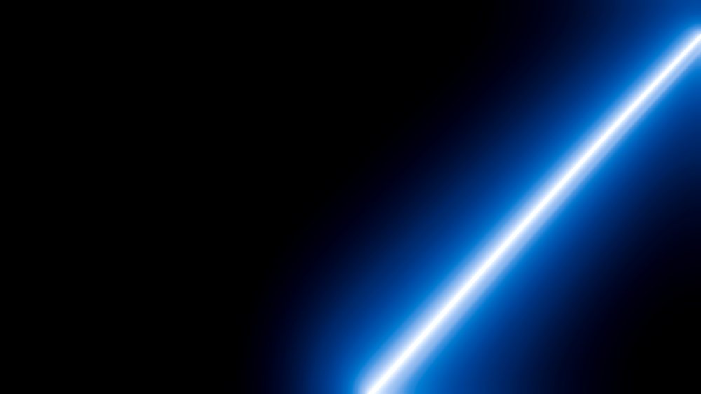 Blue glowing light streak on dark background