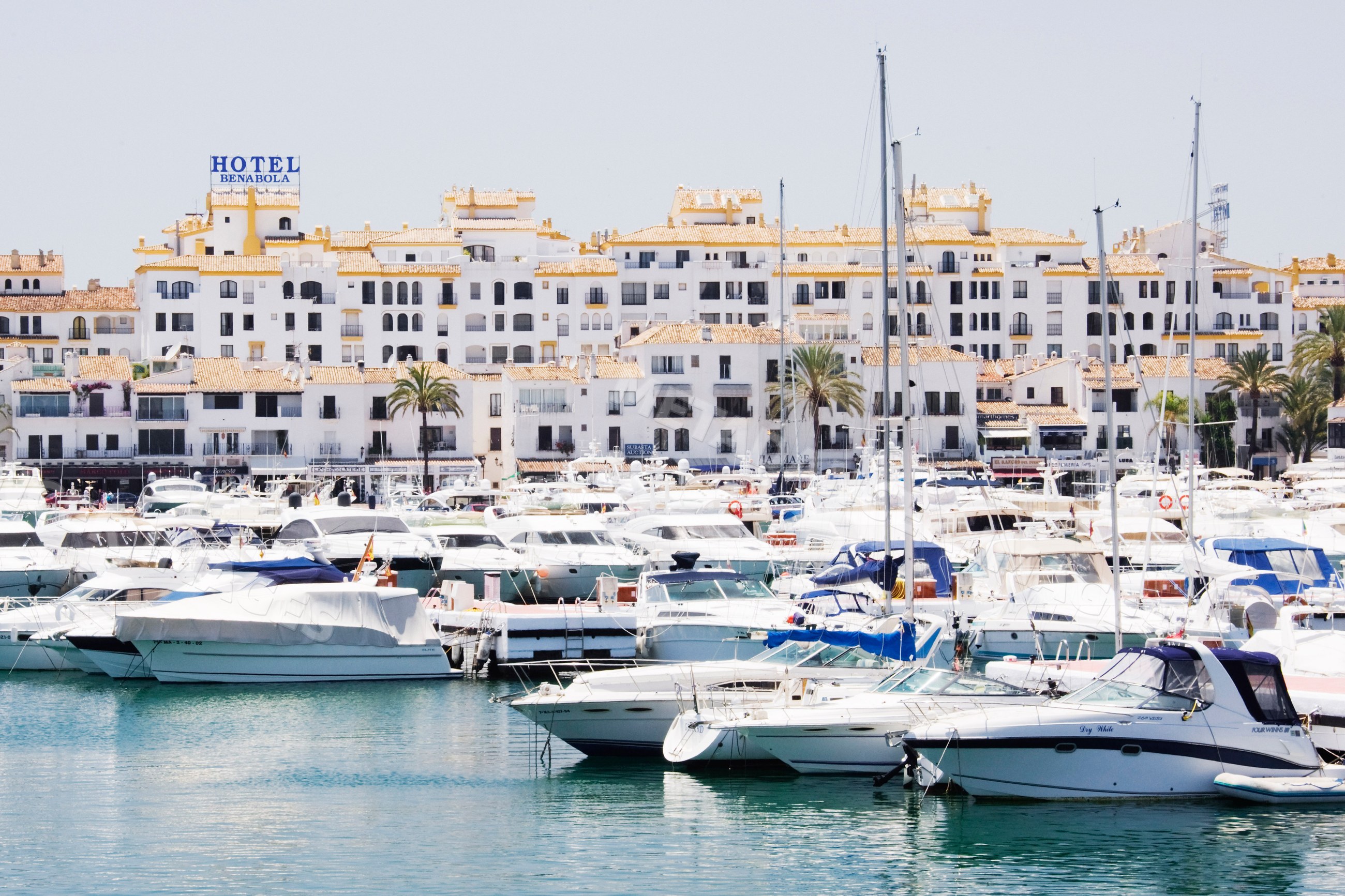 Marina with boats in front of white buildings Spain