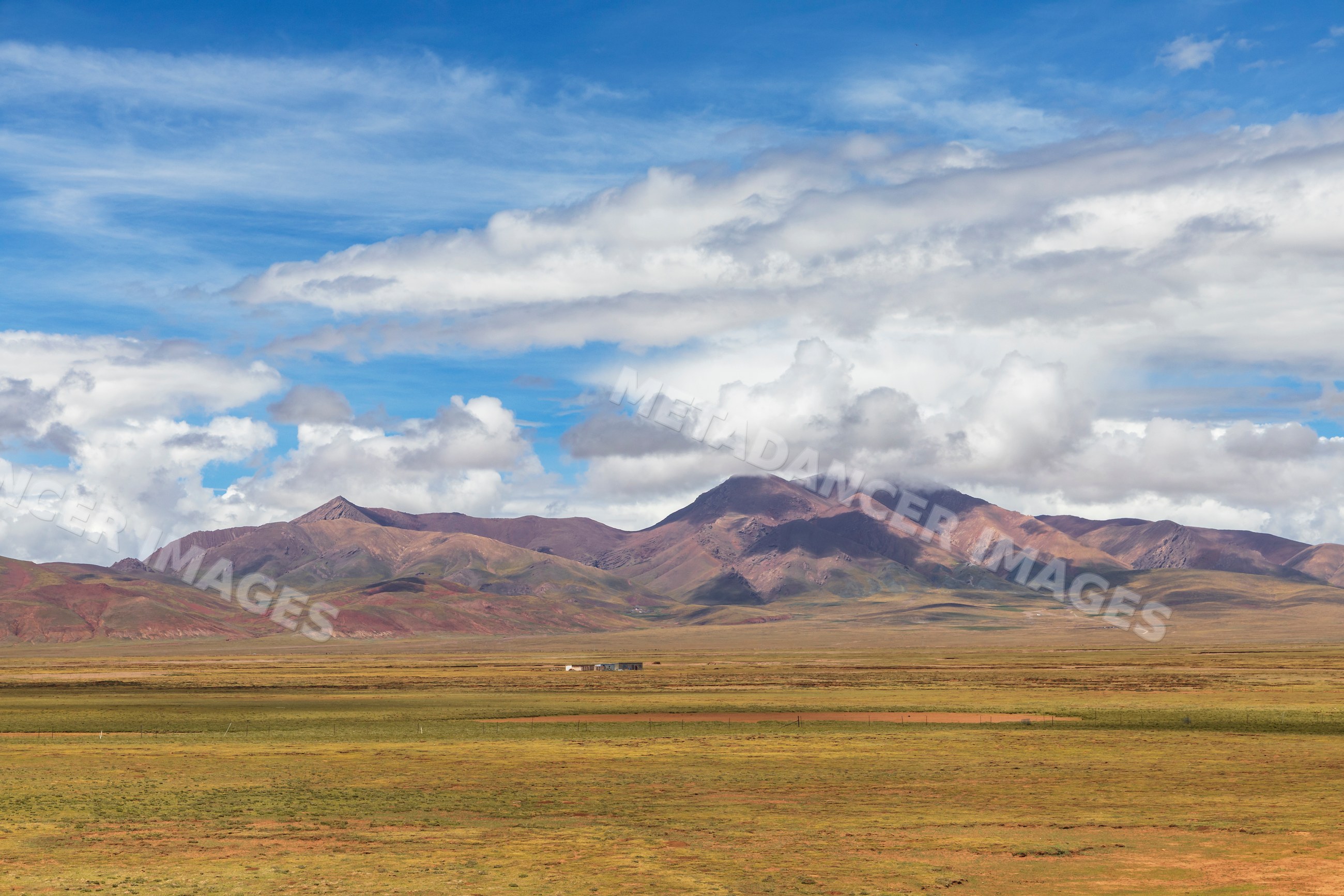 Tibetan plateau landscape with grassland and mountains