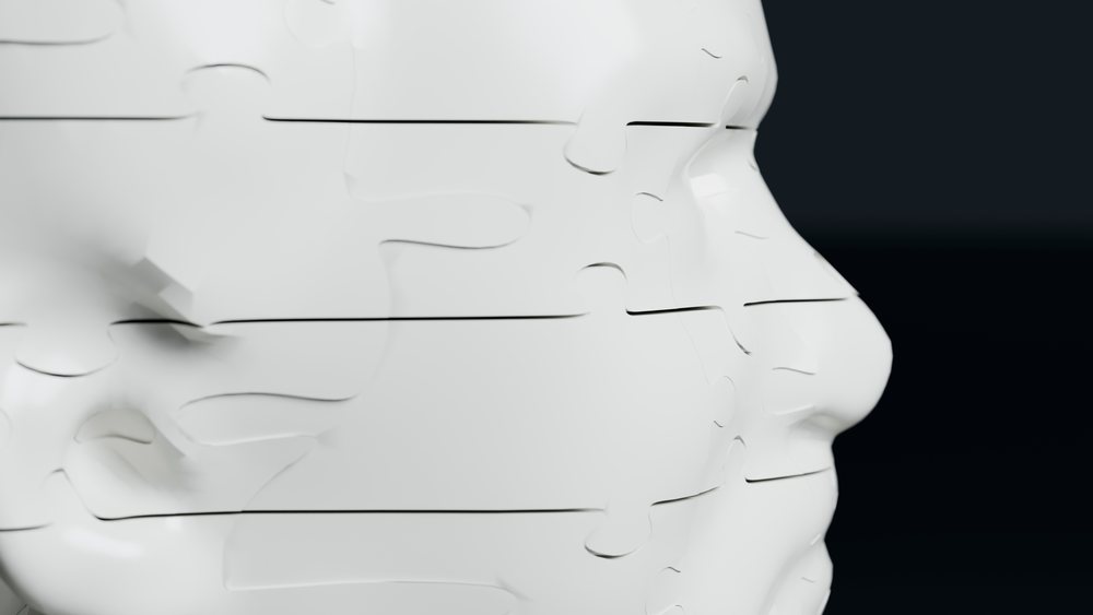 White puzzle pieces forming a human face in side view