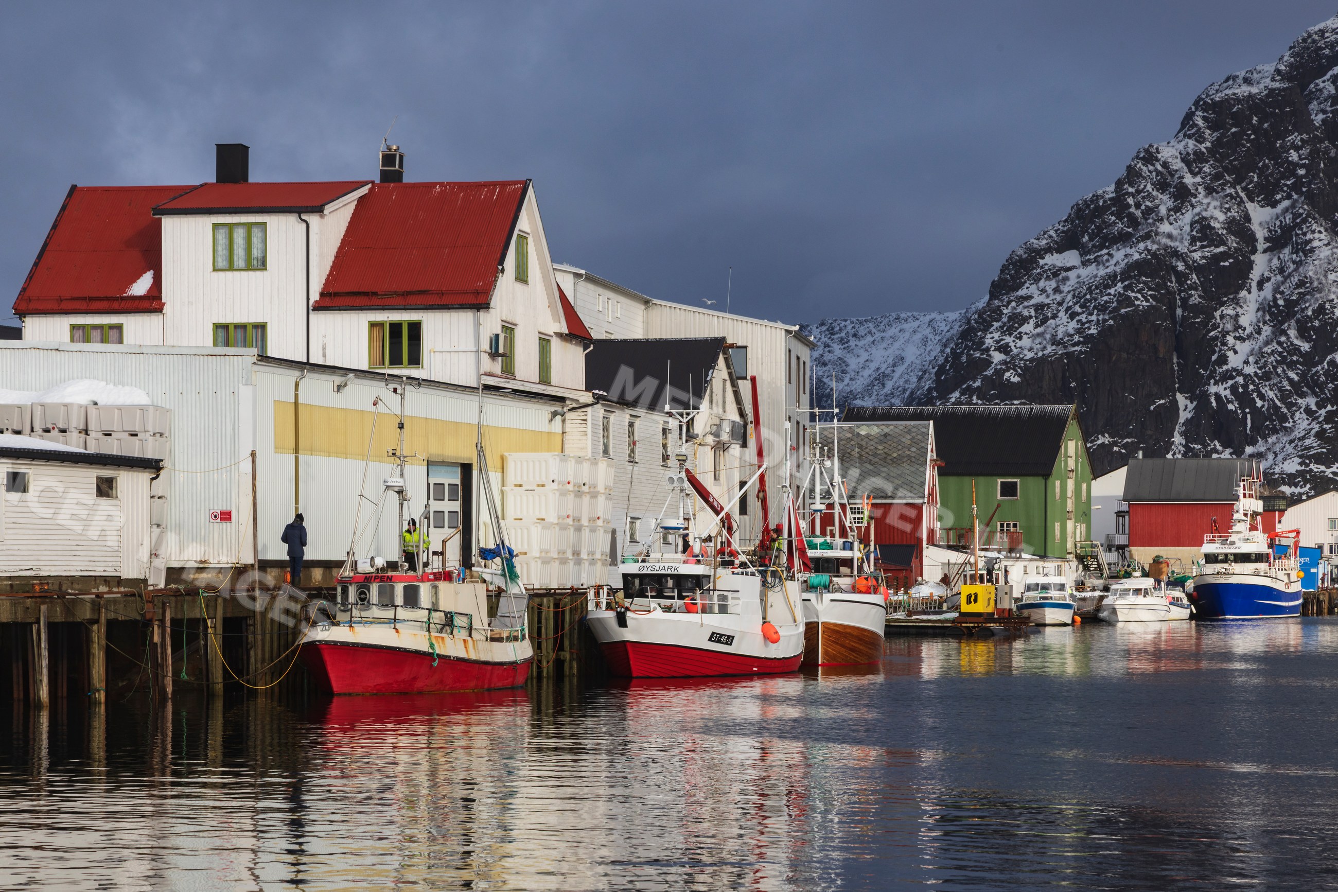 Port of Henningsvaer with fishing boats at dock in Lofoten Norway