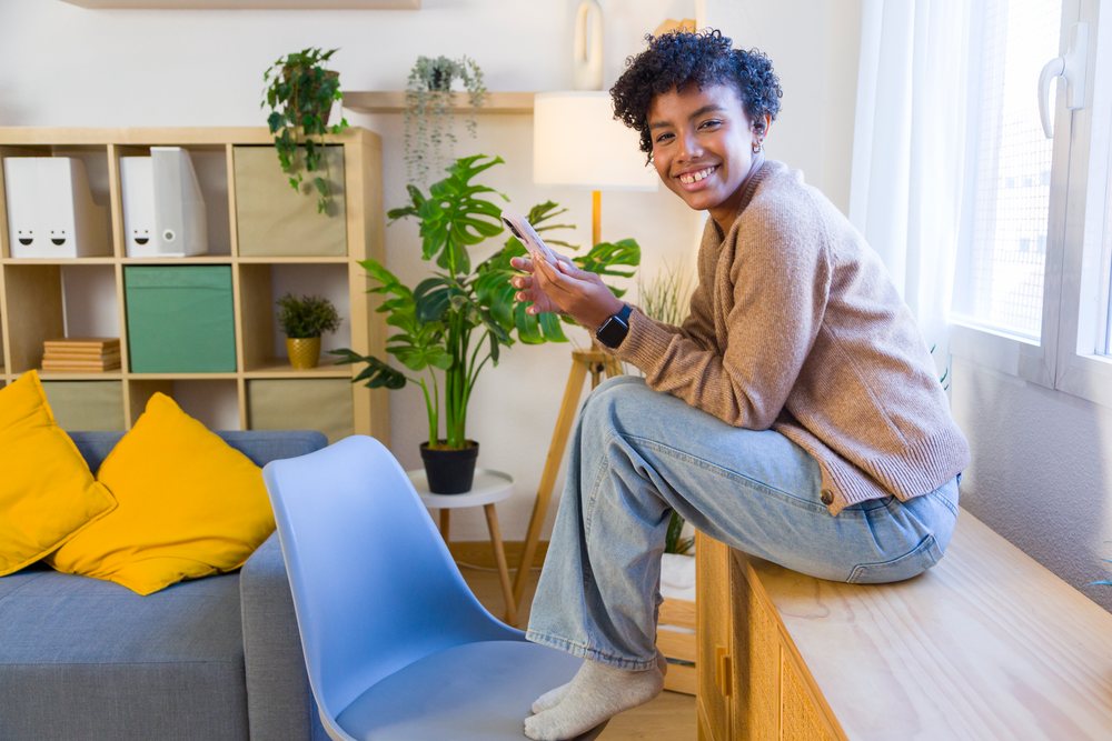 Young African American woman sitting on wooden bench
