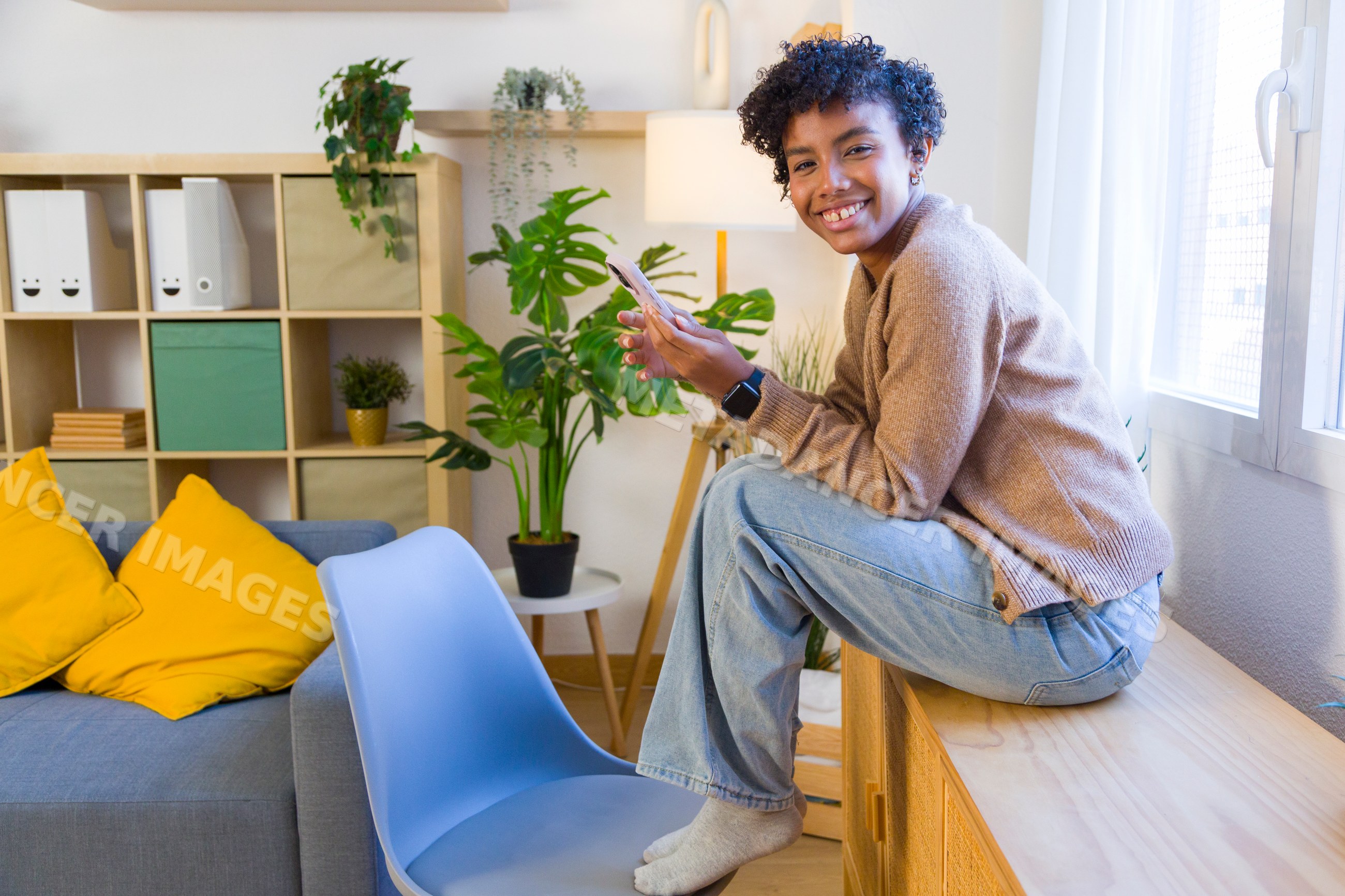 Young African American woman sitting on wooden bench