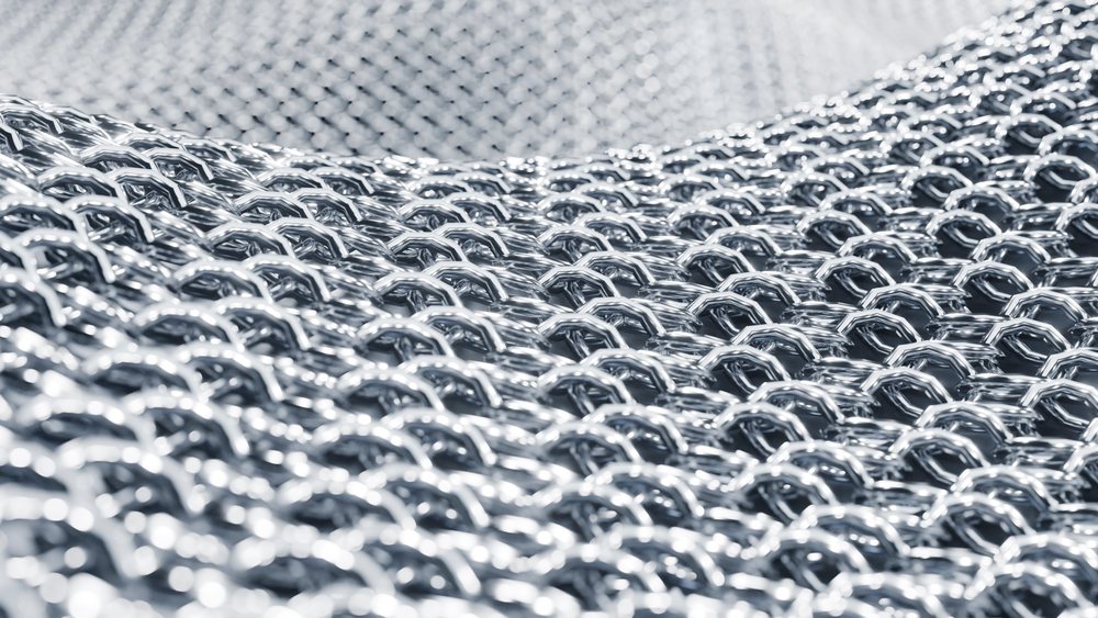 Close-up of interlinked metal rings forming chainmail armor