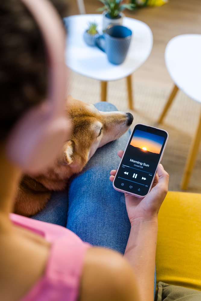 Hispanic Person relaxing with dog