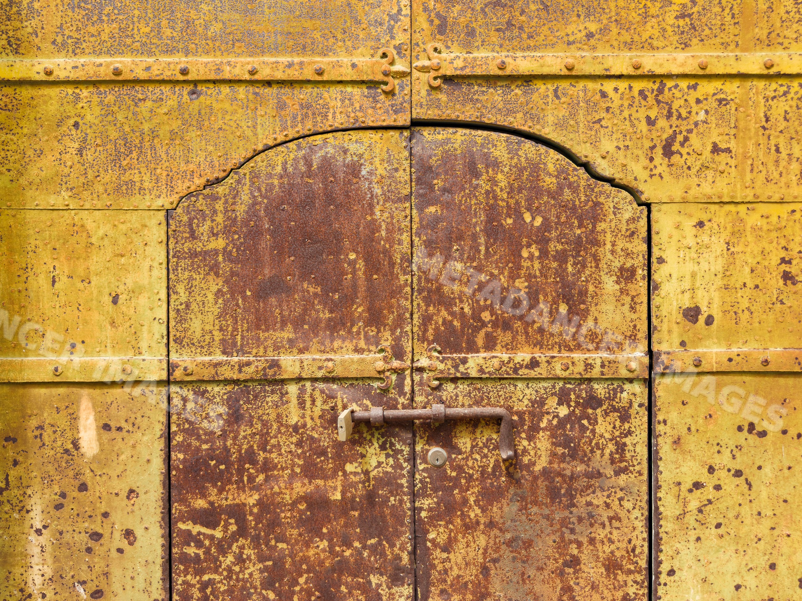 Weathered Metal Door with rust and lock