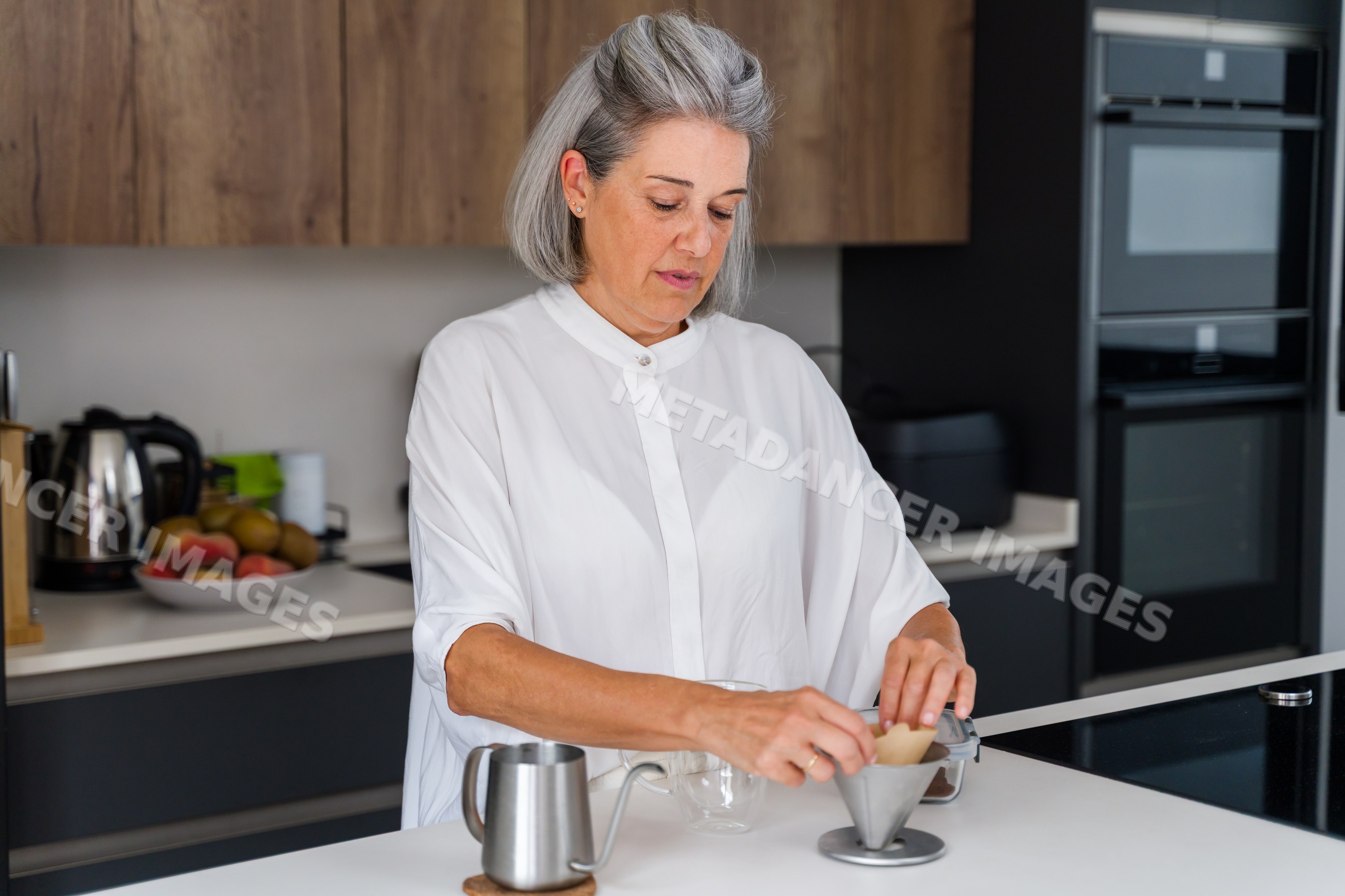 White Woman brewing coffee with pour over drip