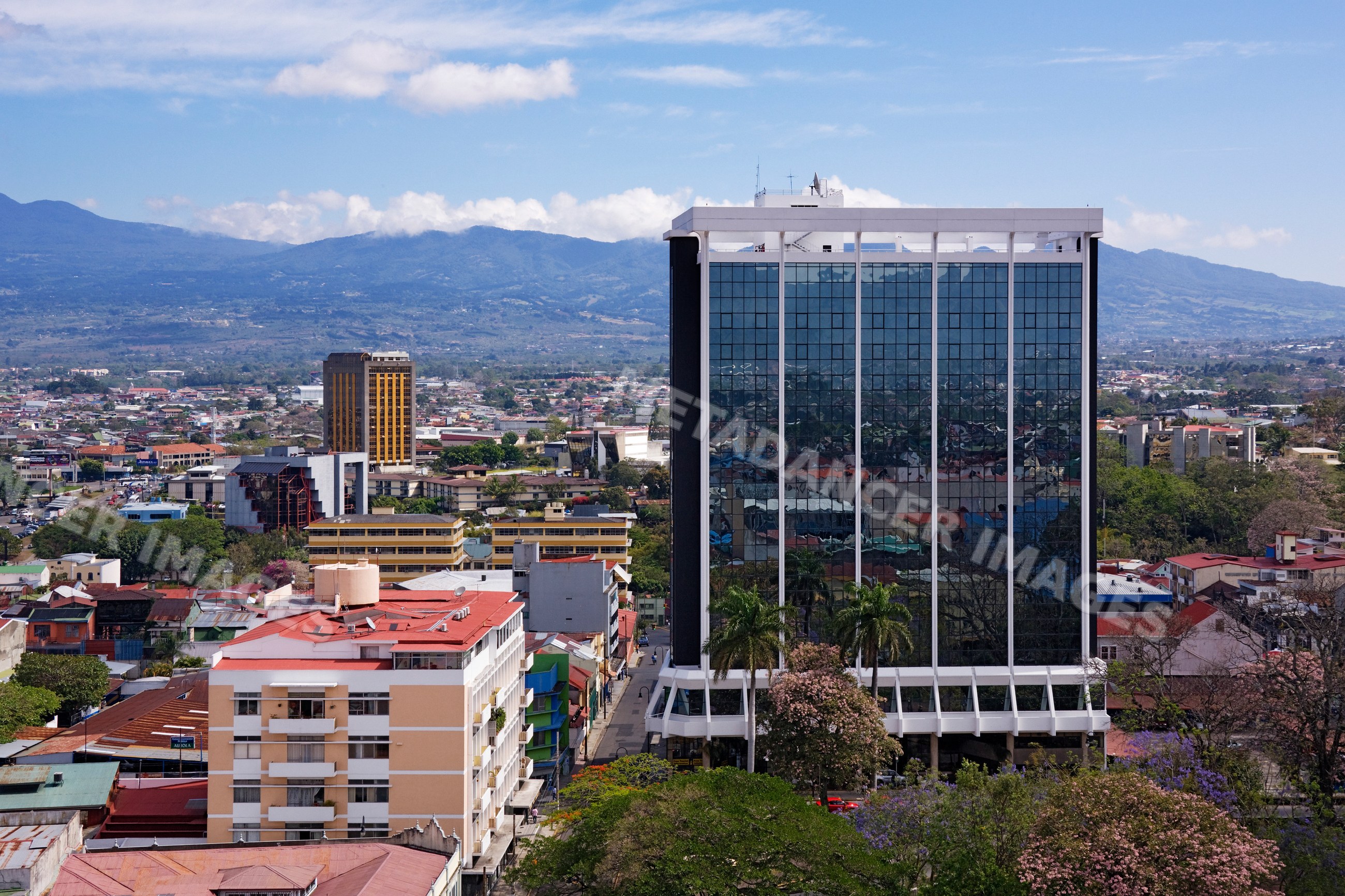 Glass facade building reflecting cityscape costa rica