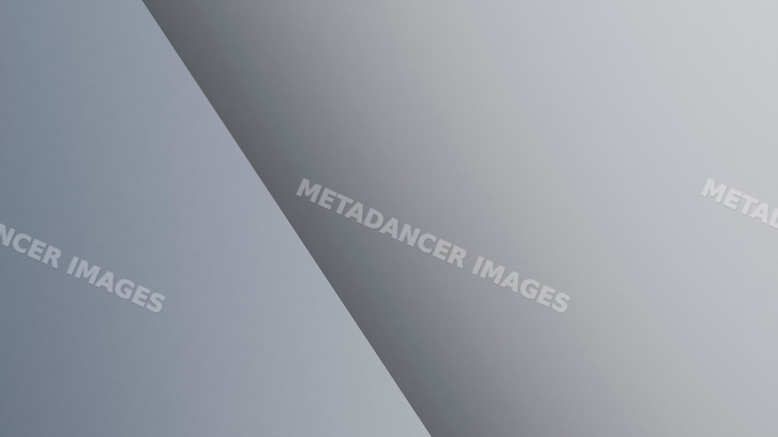 Gray surface with diagonal shadow creating minimalist abstract design