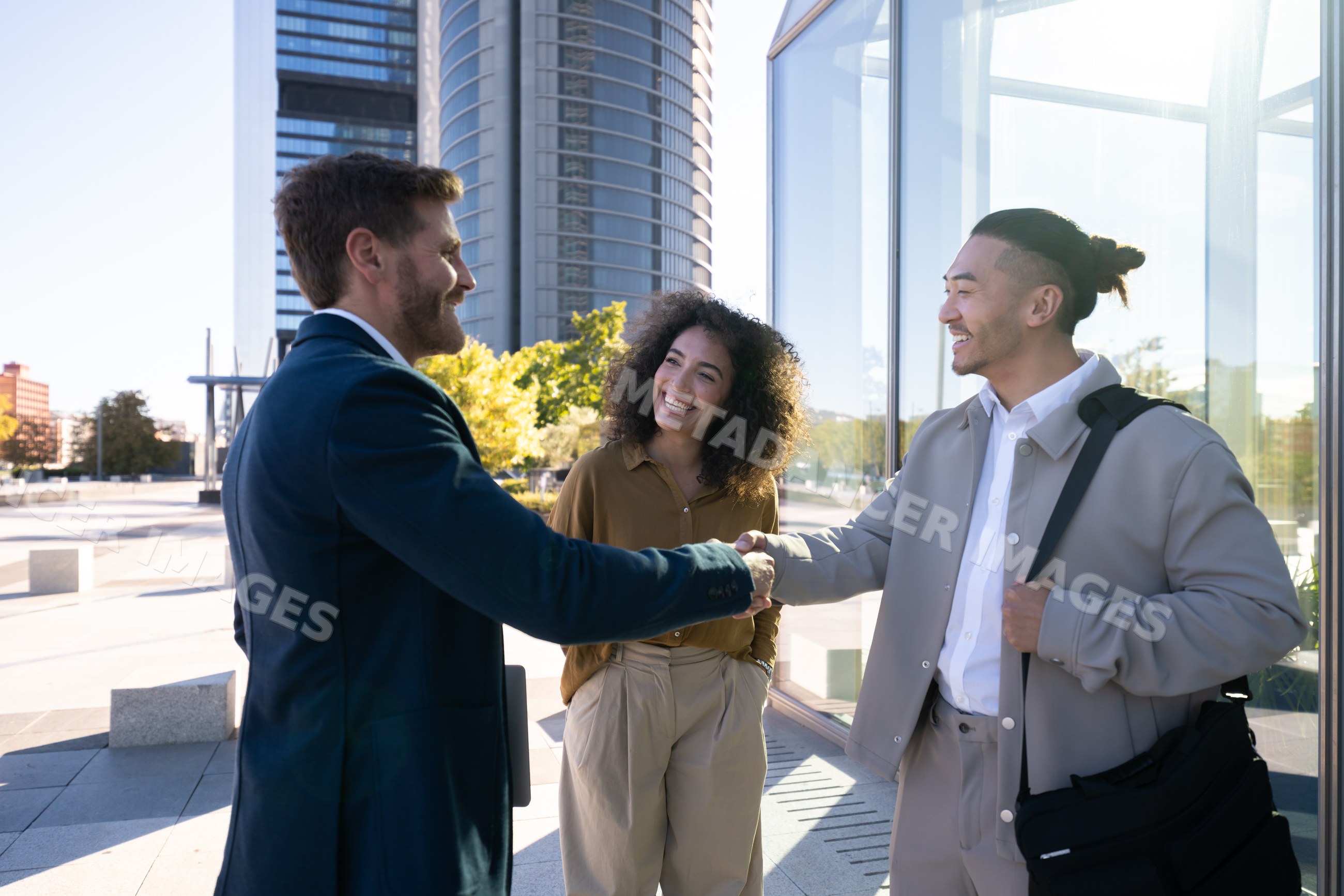 Business handshake between white professionals outside modern office