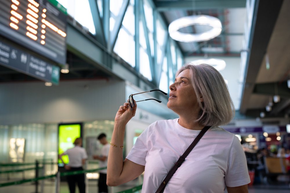 White woman holding glasses