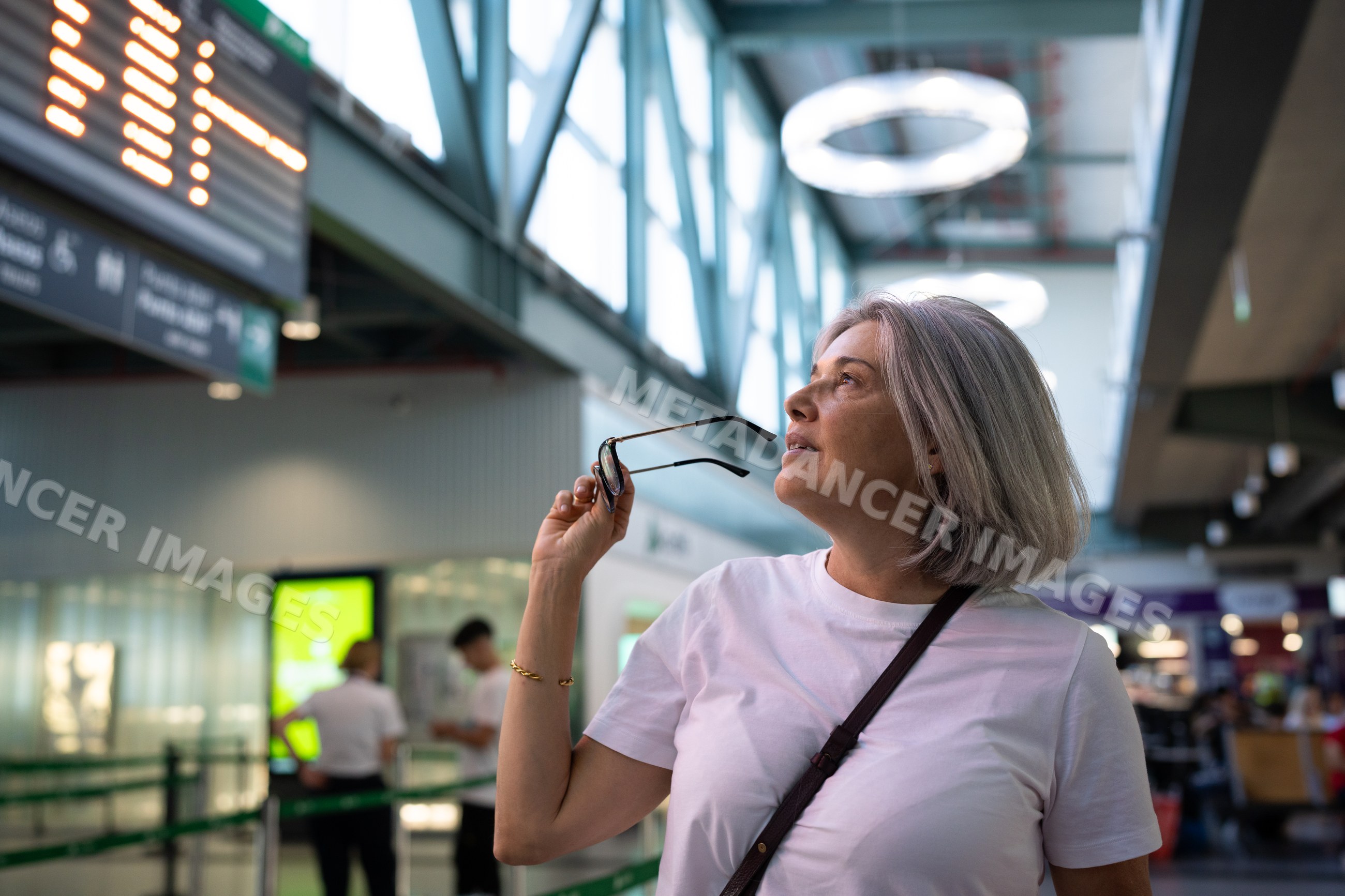 White woman holding glasses