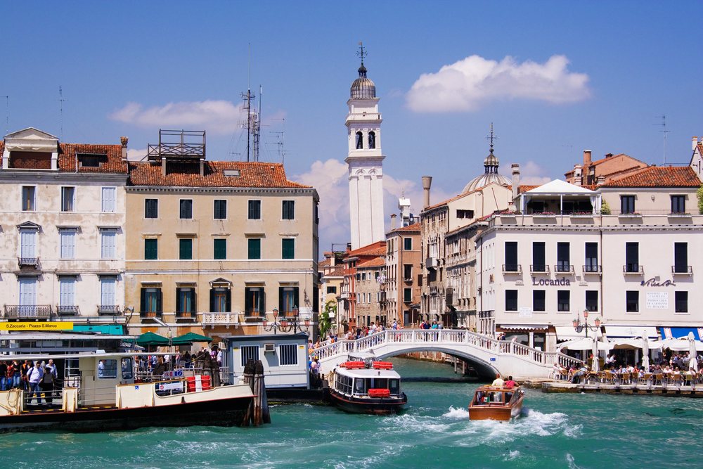 Leaning campanile of chiesa di santo stefano with canal boats