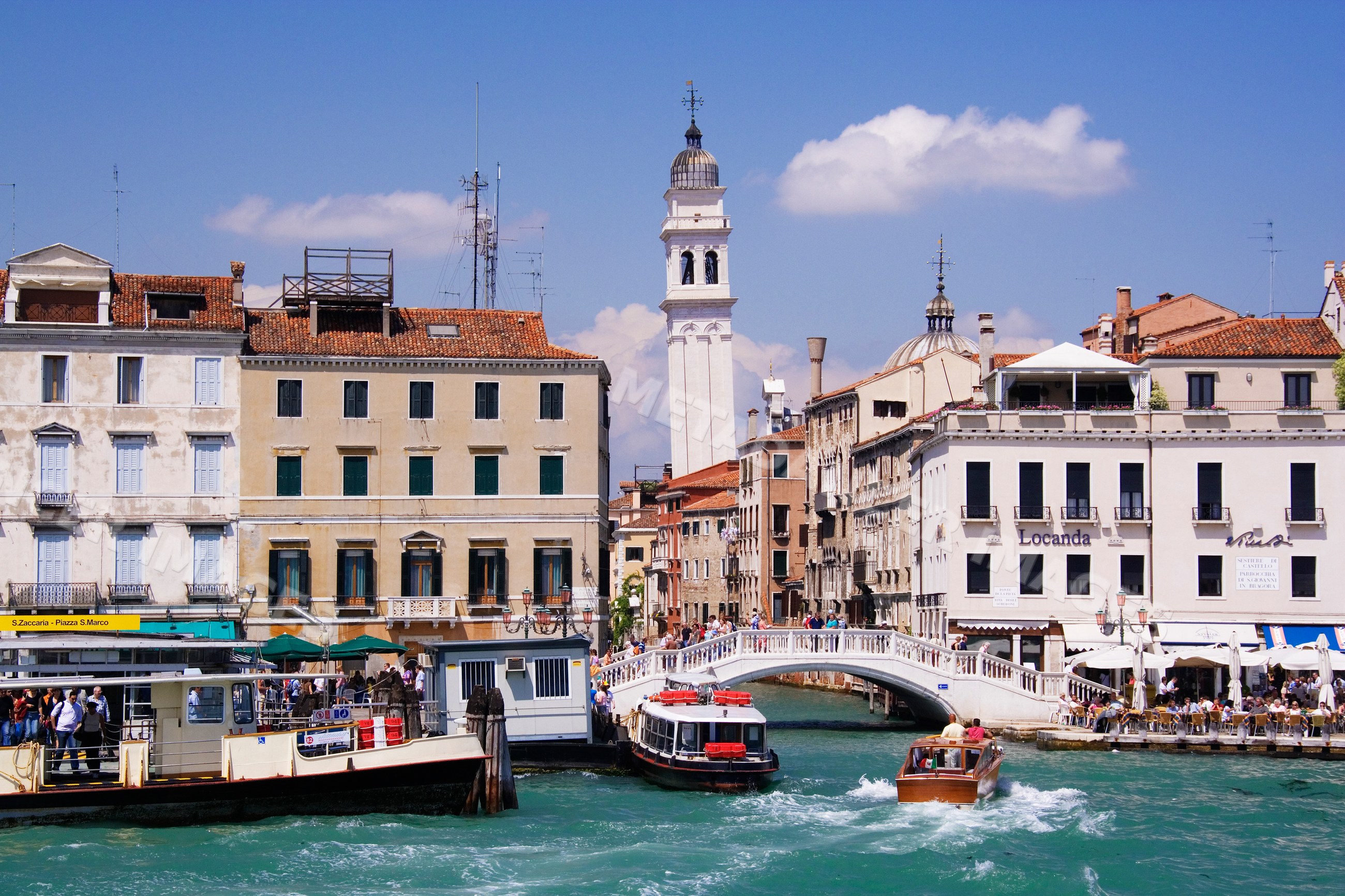 Leaning campanile of chiesa di santo stefano with canal boats