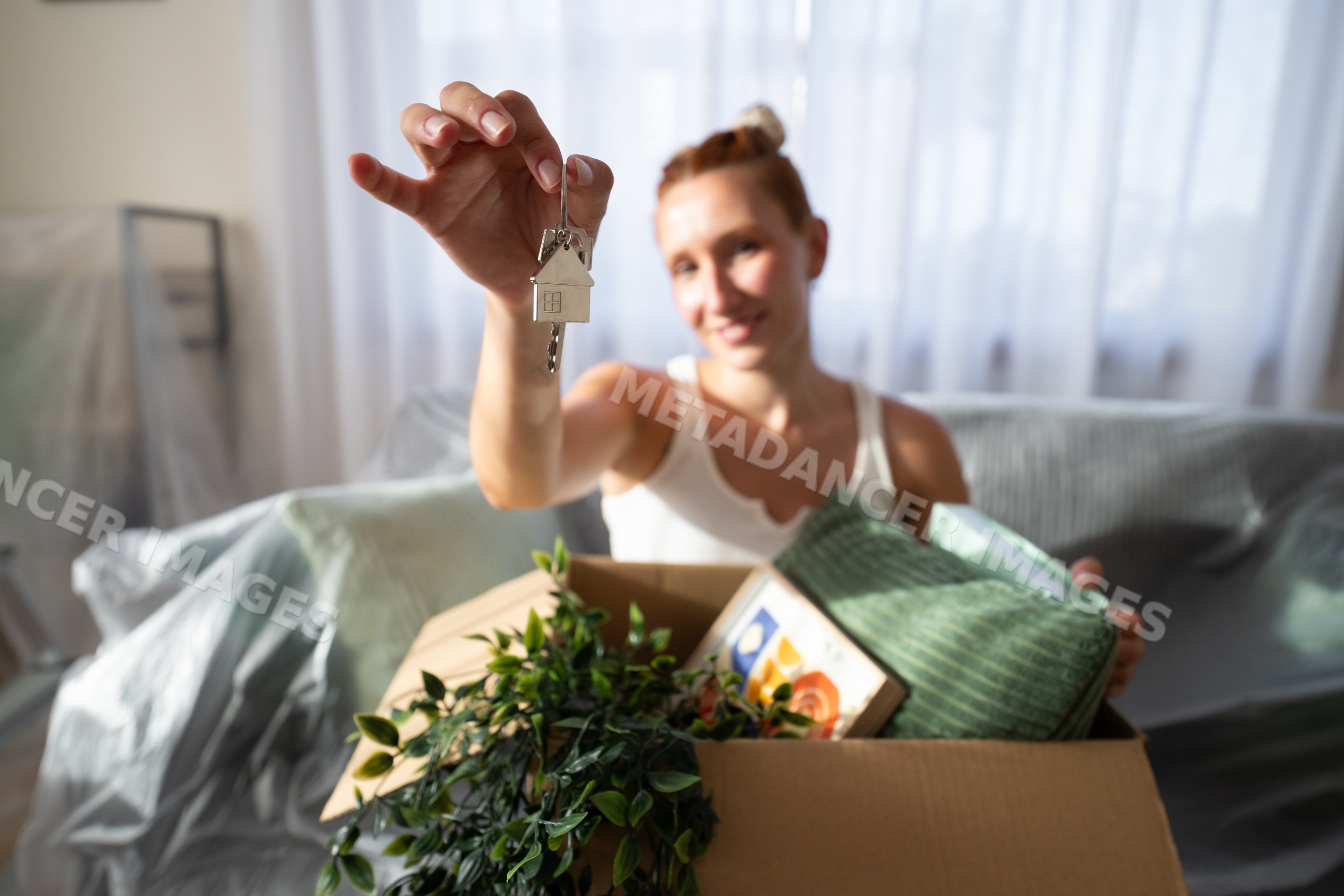A white woman holding house keys