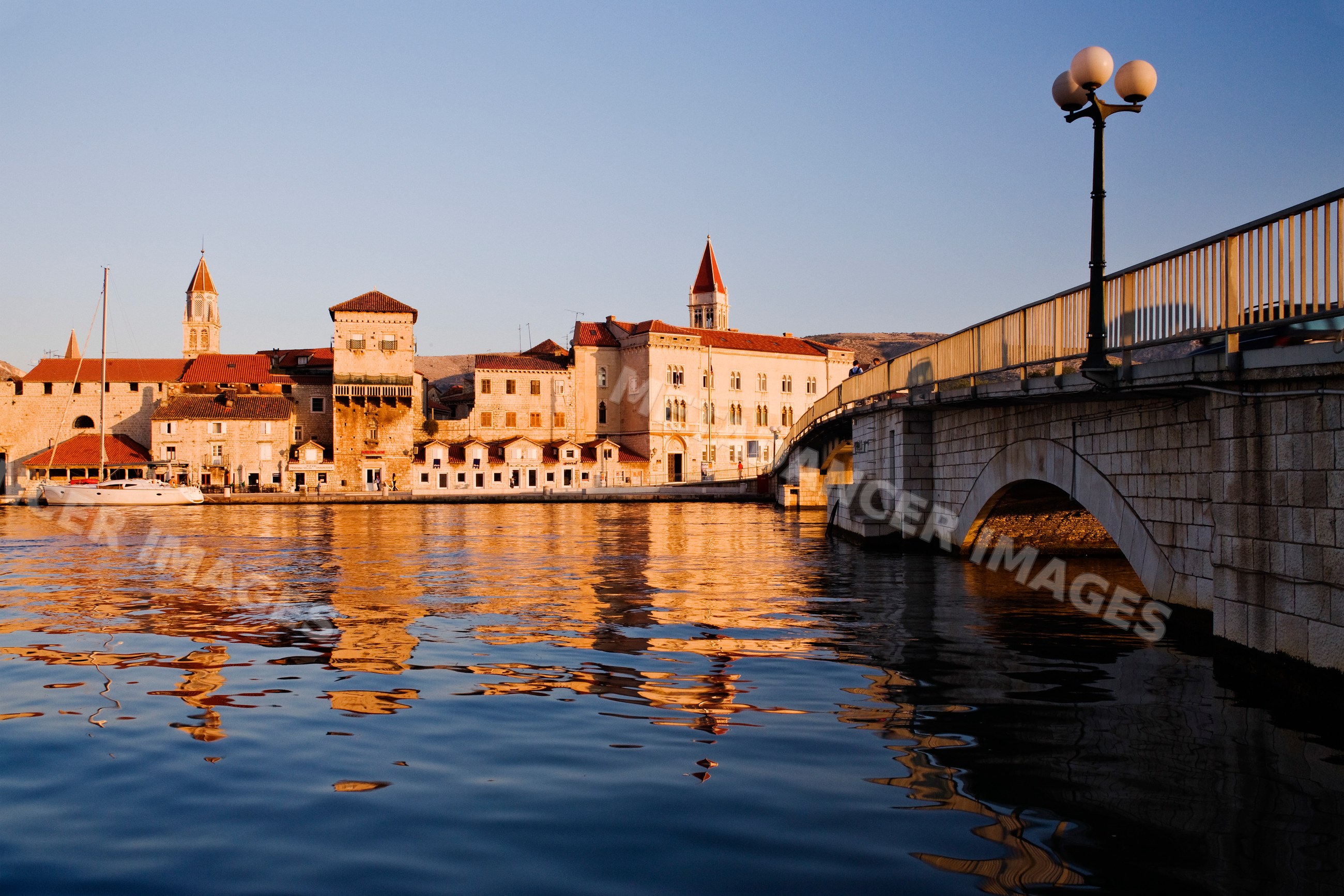 Town of trogir at dawn reflecting on water
