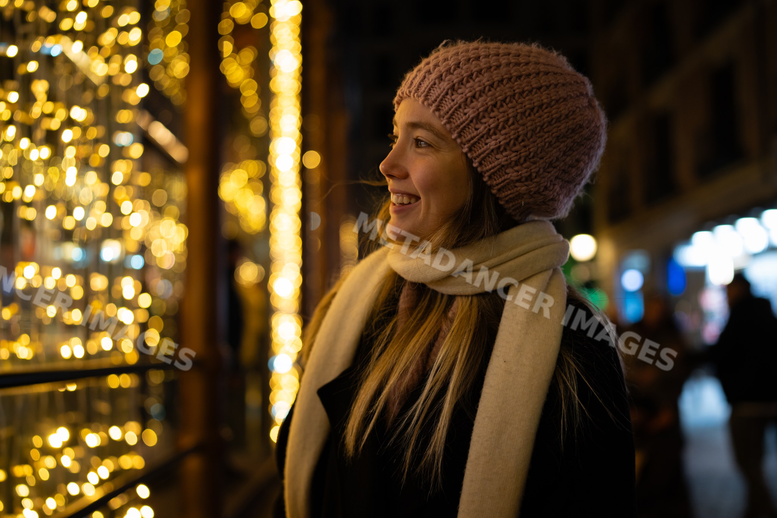 White woman enjoying christmas market holiday lights