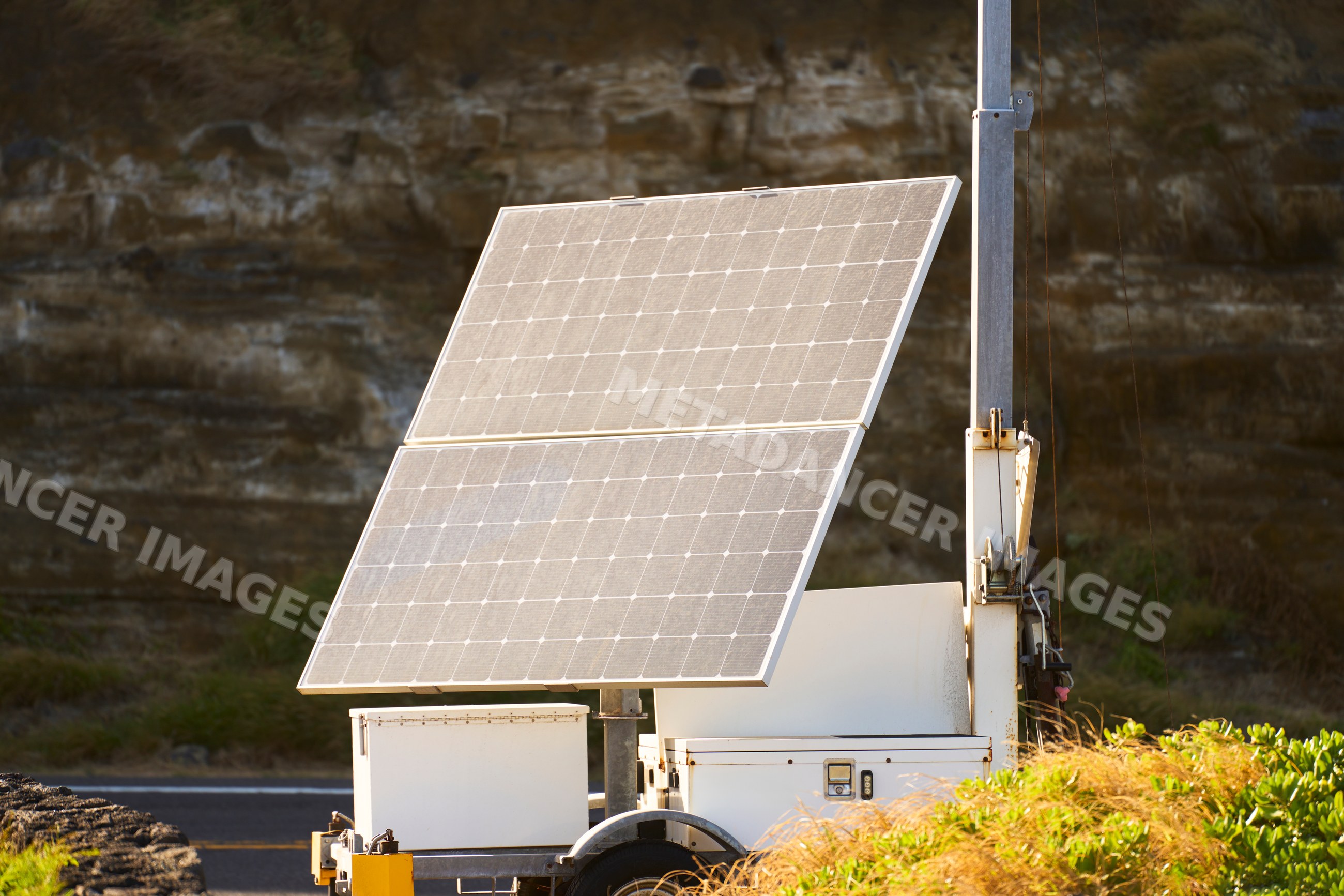 Solar panels mounted on trailer base capturing sunlight outdoors