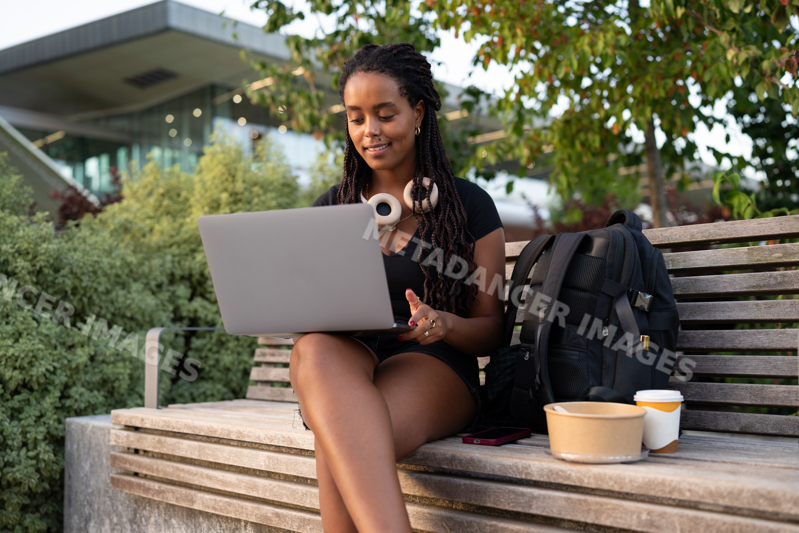 A African American woman works on her laptop outdoors in Santiago
