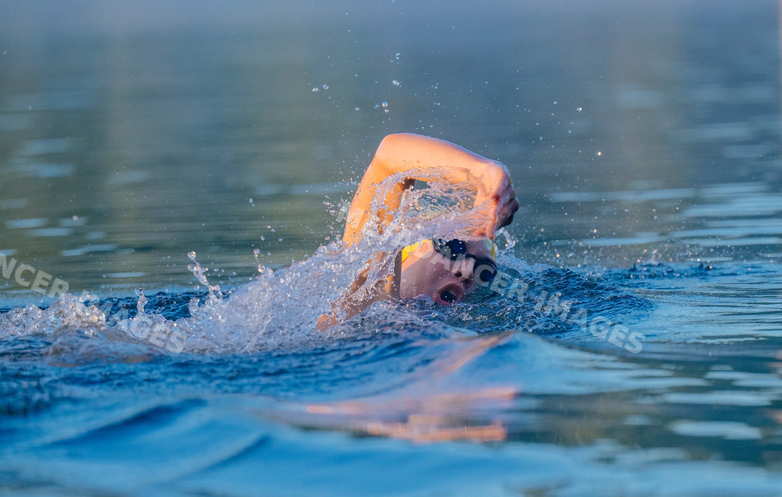 White swimmer performing freestyle stroke in open water