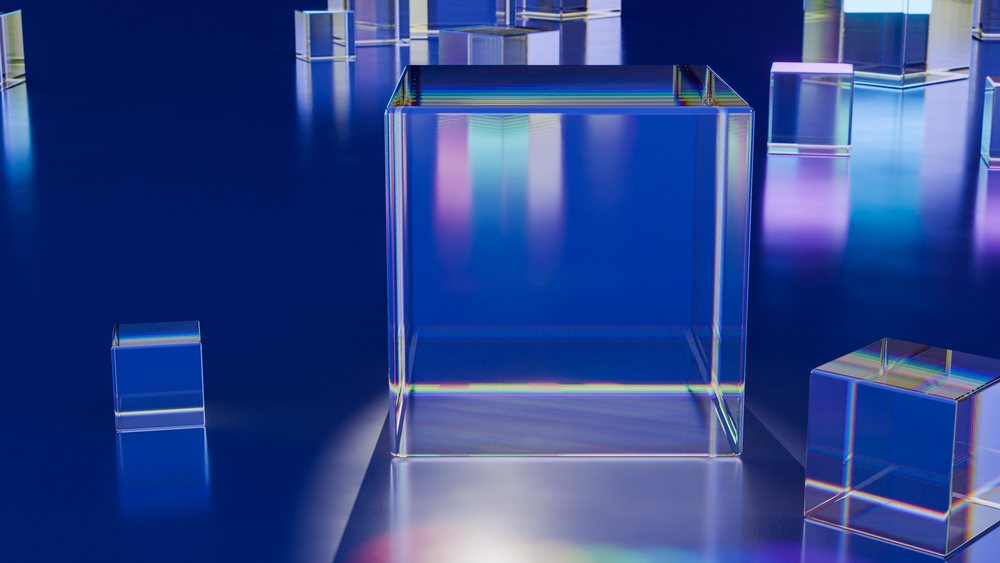 Transparent glass cubes with light refraction on blue surface