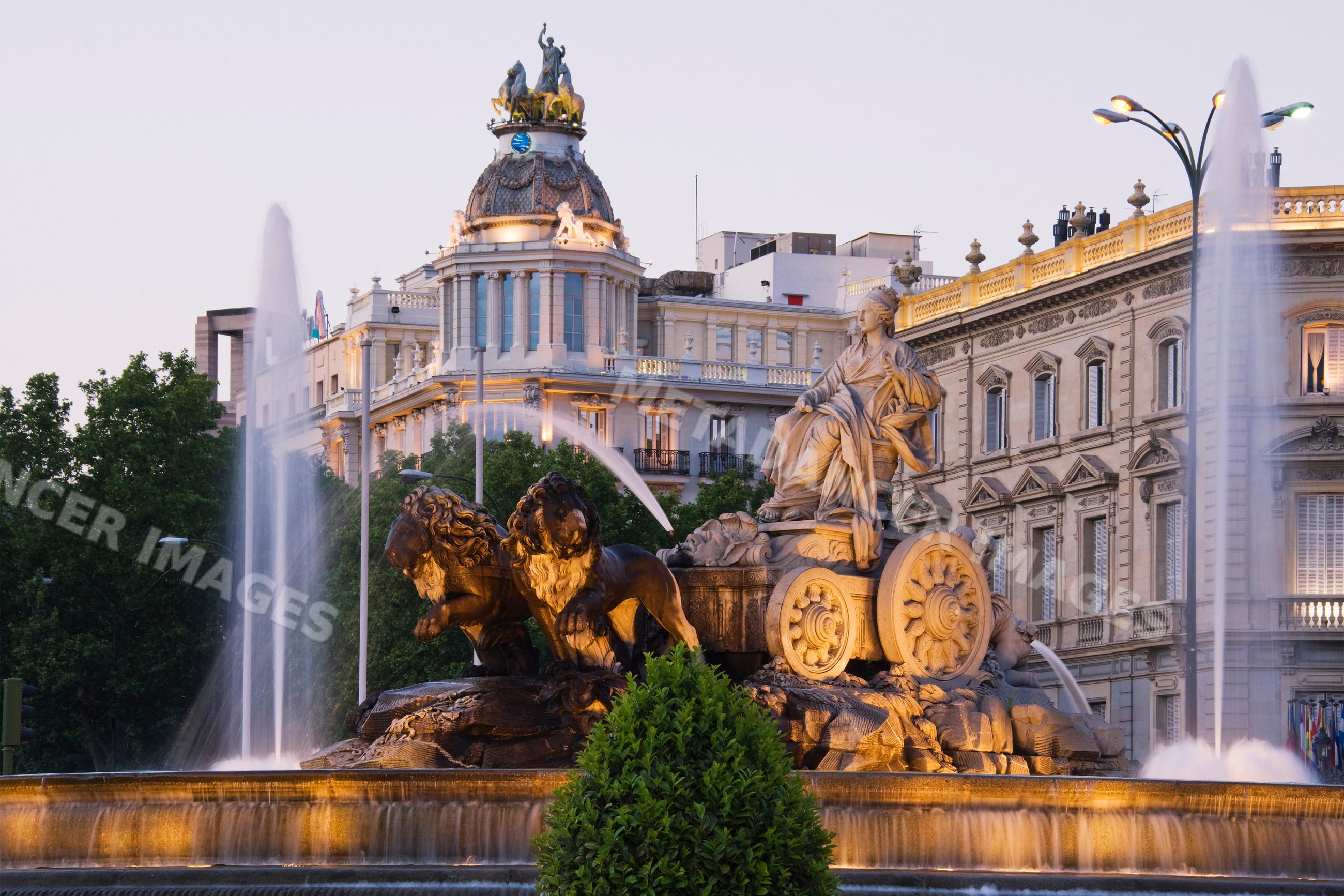 Cibeles fountain and mariblanca statue at sunset