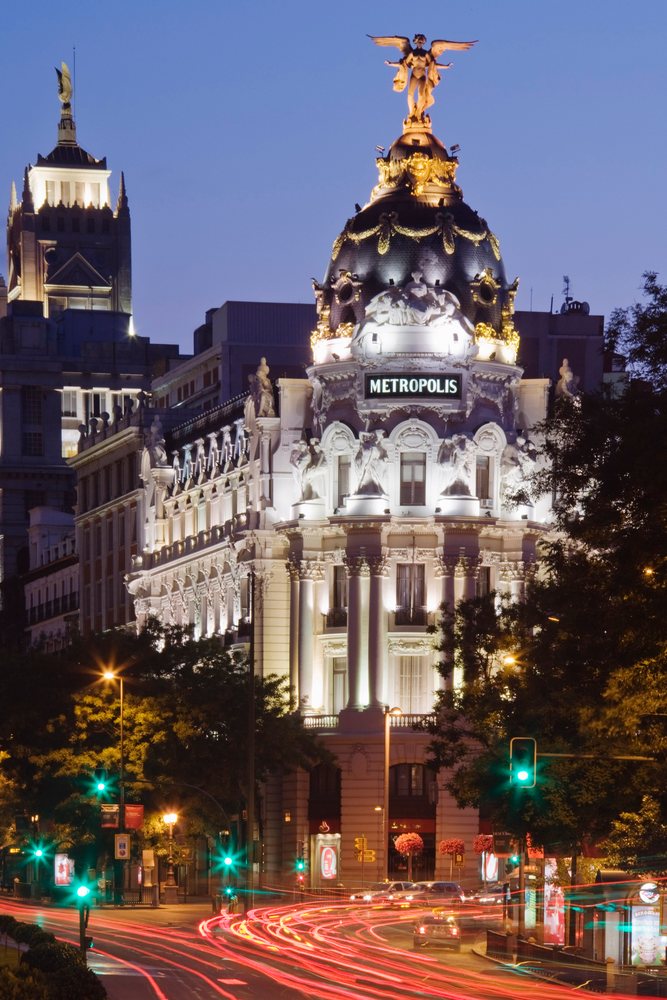 Metropolis building illuminated at night with traffic trails