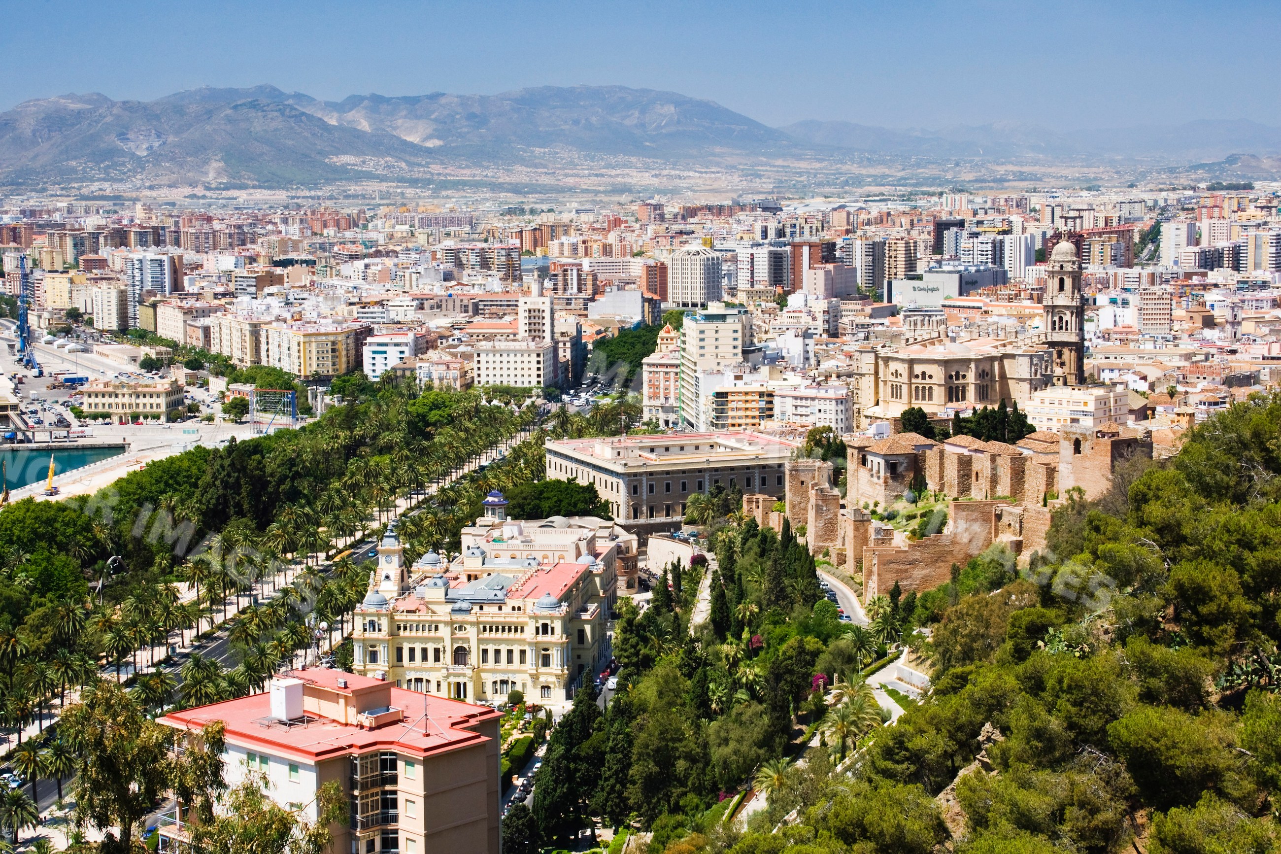 Malaga cityscape with historic architecture and mountains, Spain