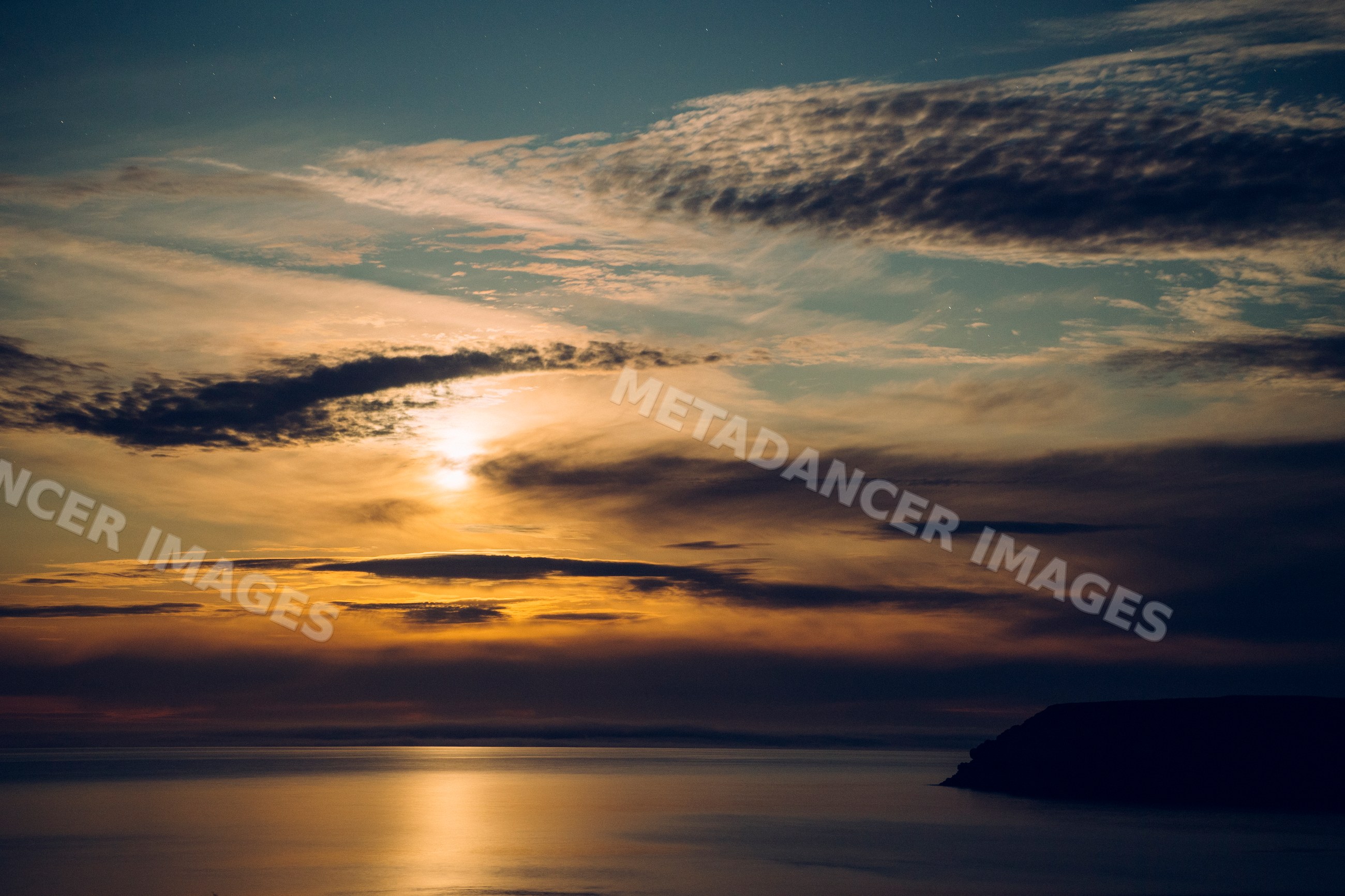 Sunset over ocean with coastal cliff and dramatic clouds Oregon