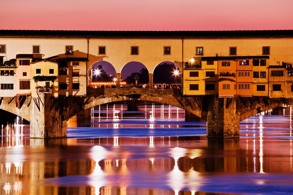 Ponte vecchio bridge over river arno at sunset italy