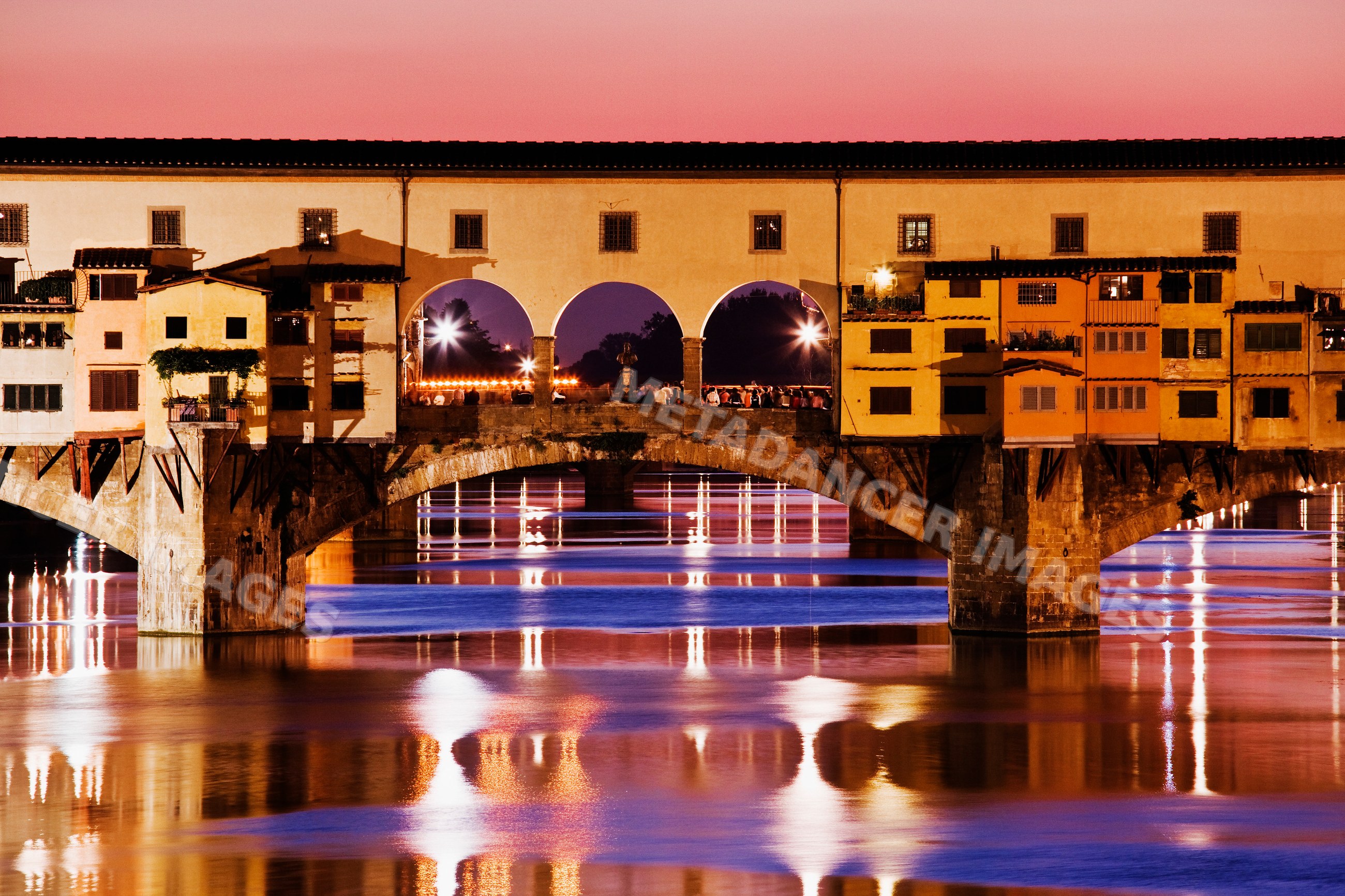 Ponte vecchio bridge over river arno at sunset italy