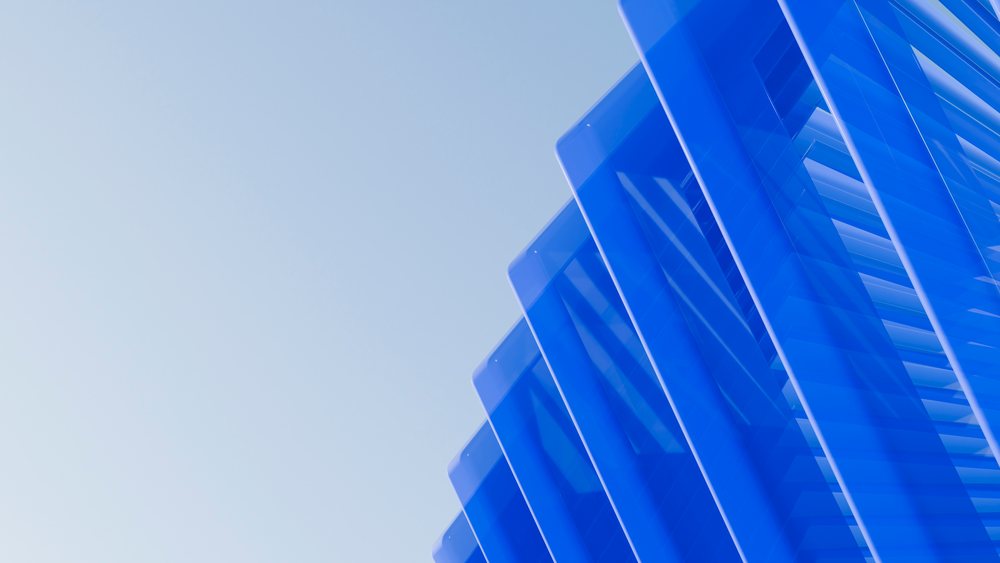 Blue glass architectural panels forming modern geometric structure