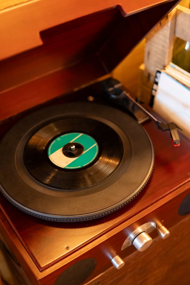 Vinyl record playing on a vintage wooden turntable in Verdun France