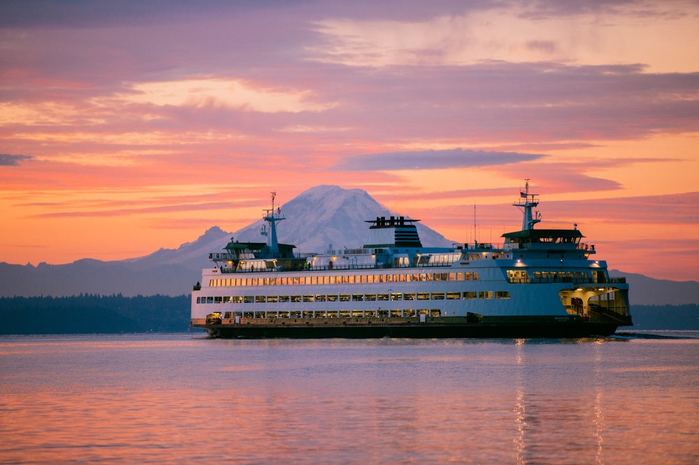 Ferry sailing at sunset with mount rainier in the background