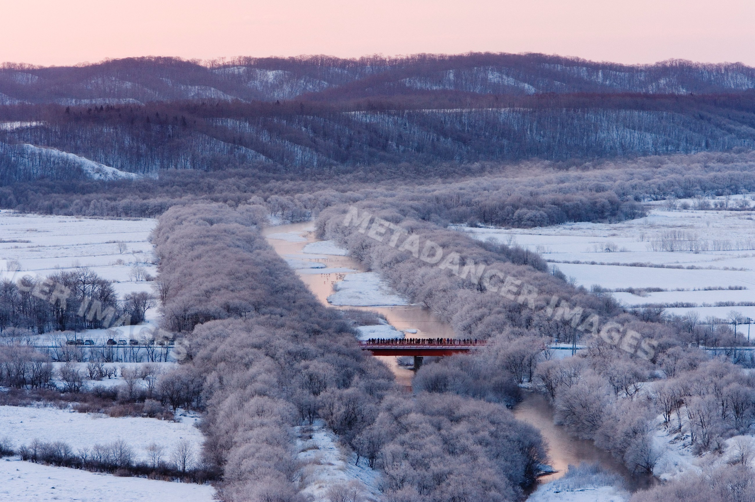 Bridge over river with frosted trees in winter landscape japan
