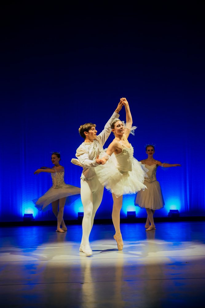 Ballet dancers perform a holiday-themed ballet dance on stage