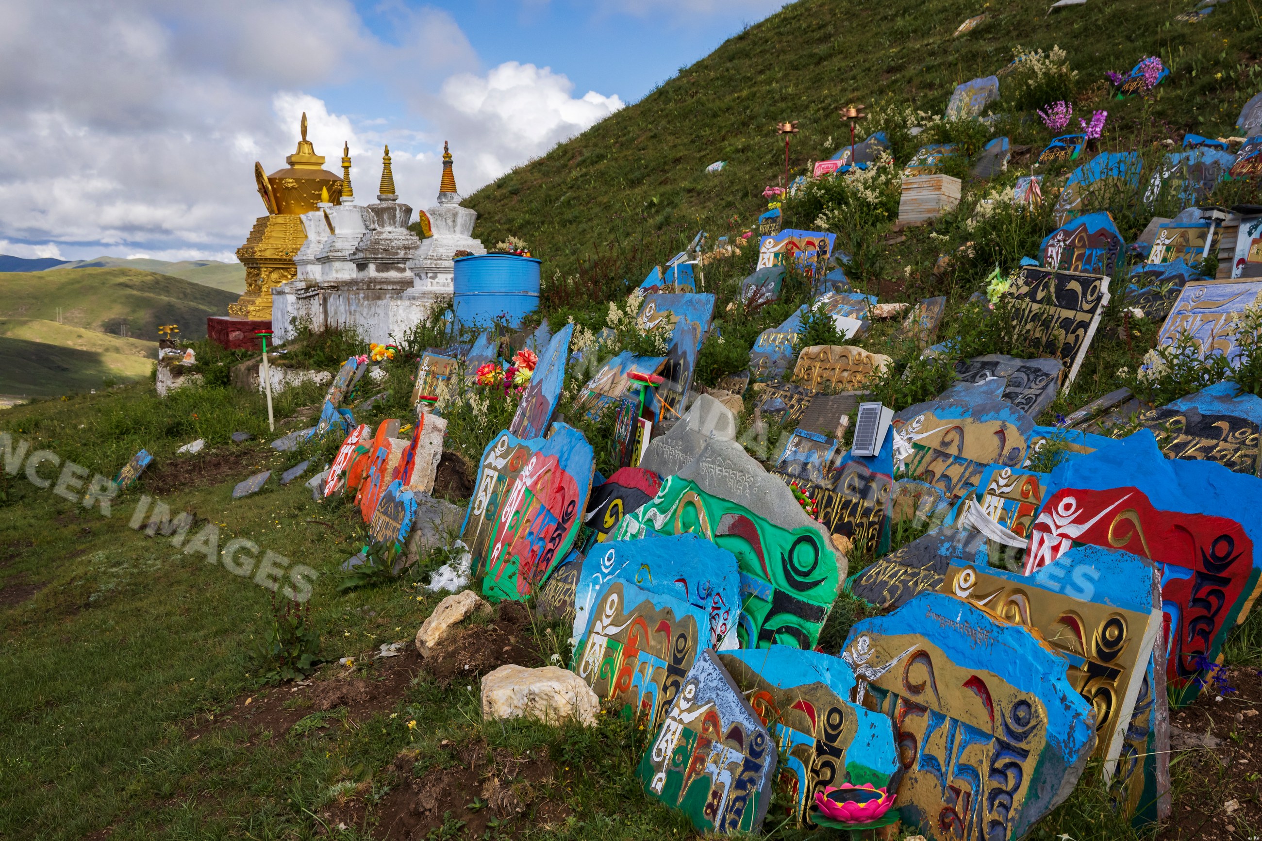 Colorful painted Mani Stones on hillside