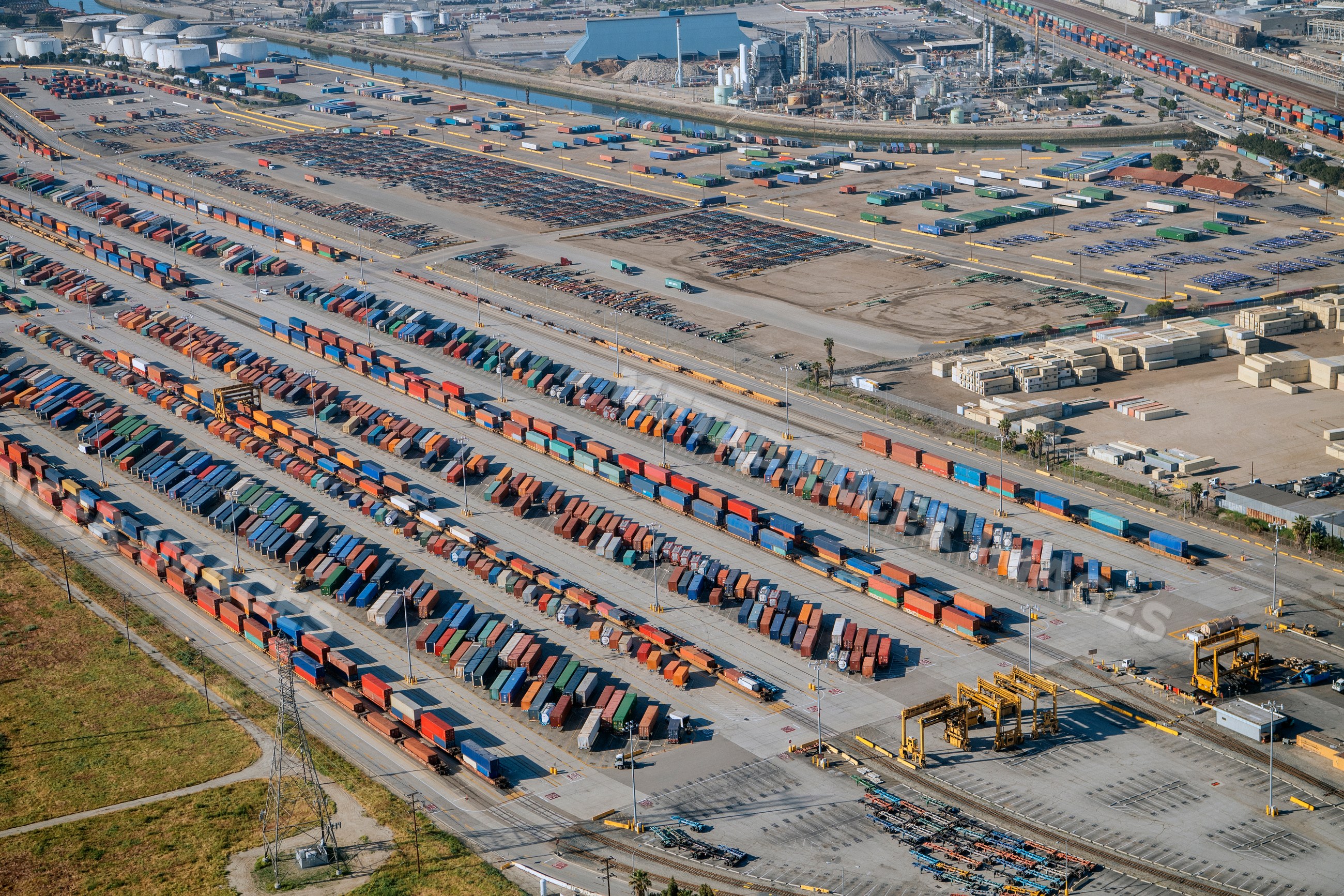 Container yard with freight containers and cargo equipment in a beach