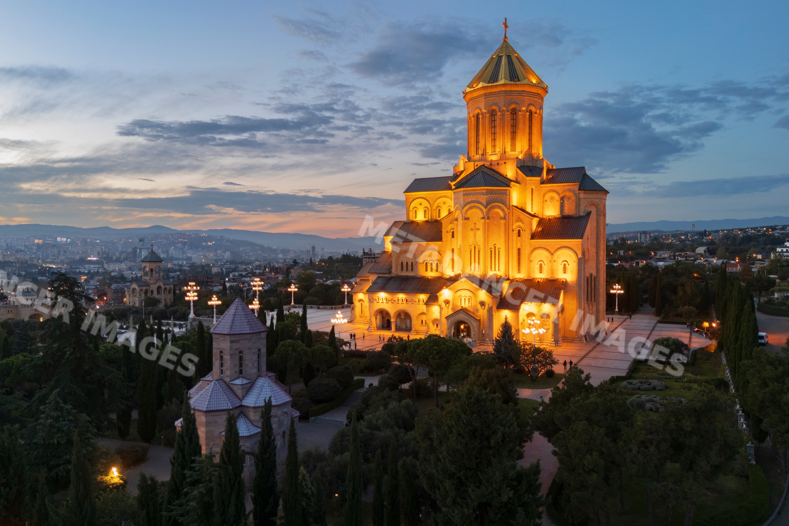 Holy trinity cathedral of Tbilisi illuminated at Dusk with cityscape