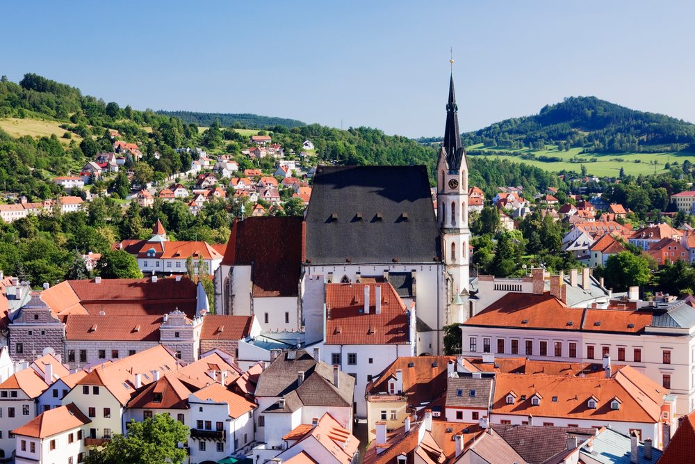 Church of st vitus in cesky krumlov with surrounding rooftops