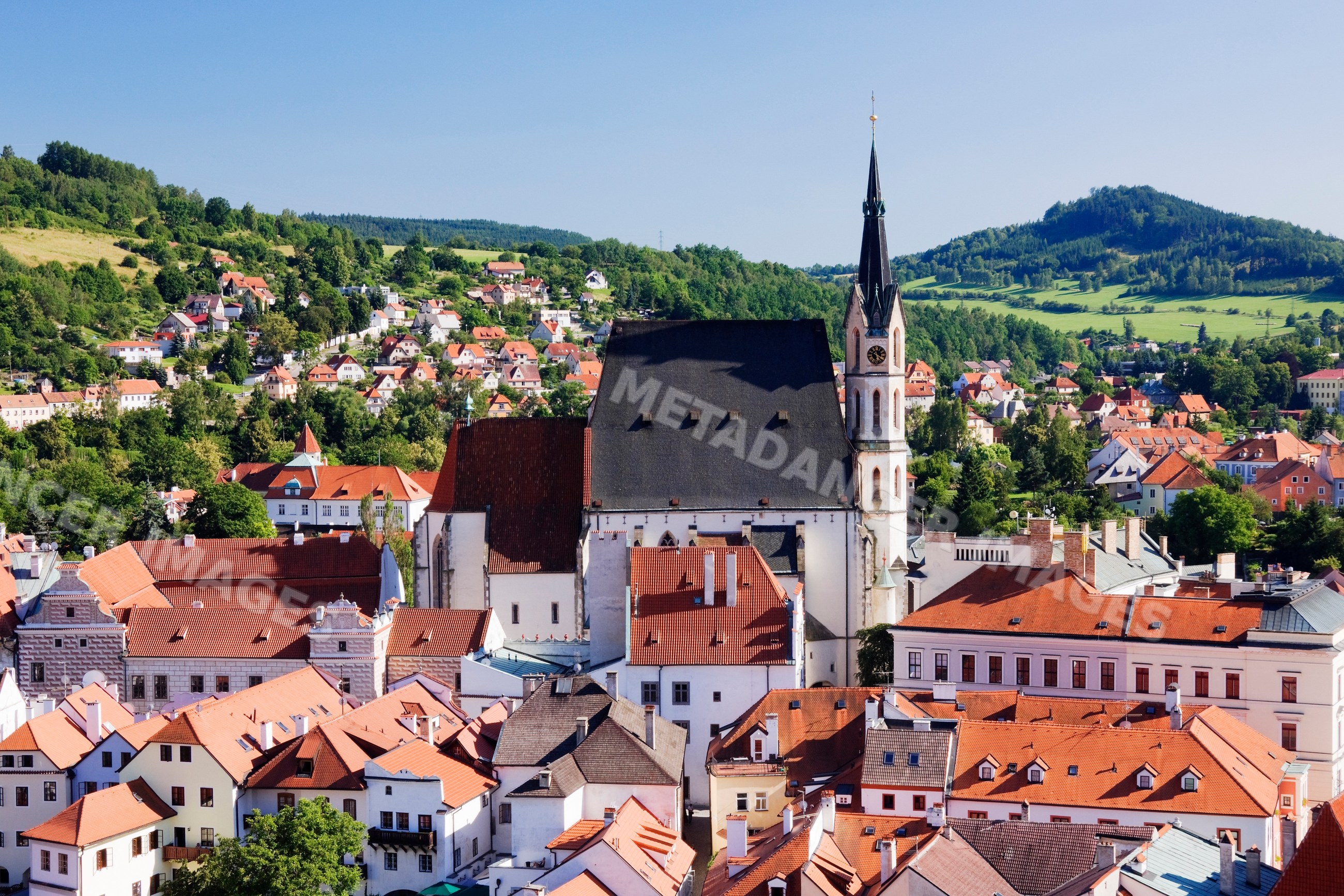 Church of st vitus in cesky krumlov with surrounding rooftops