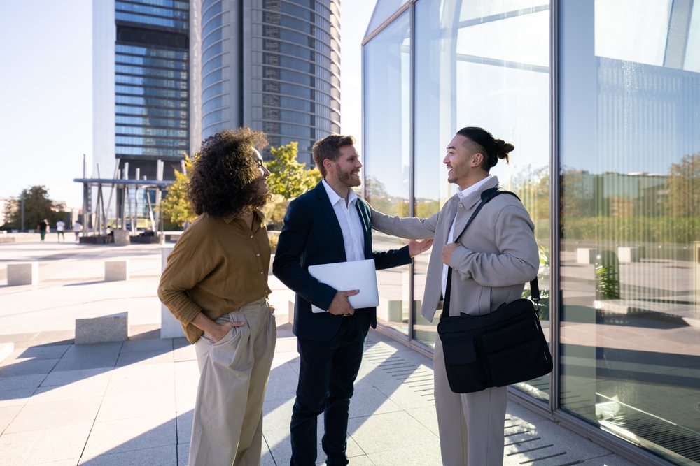 Business white professionals discussing outside modern office building