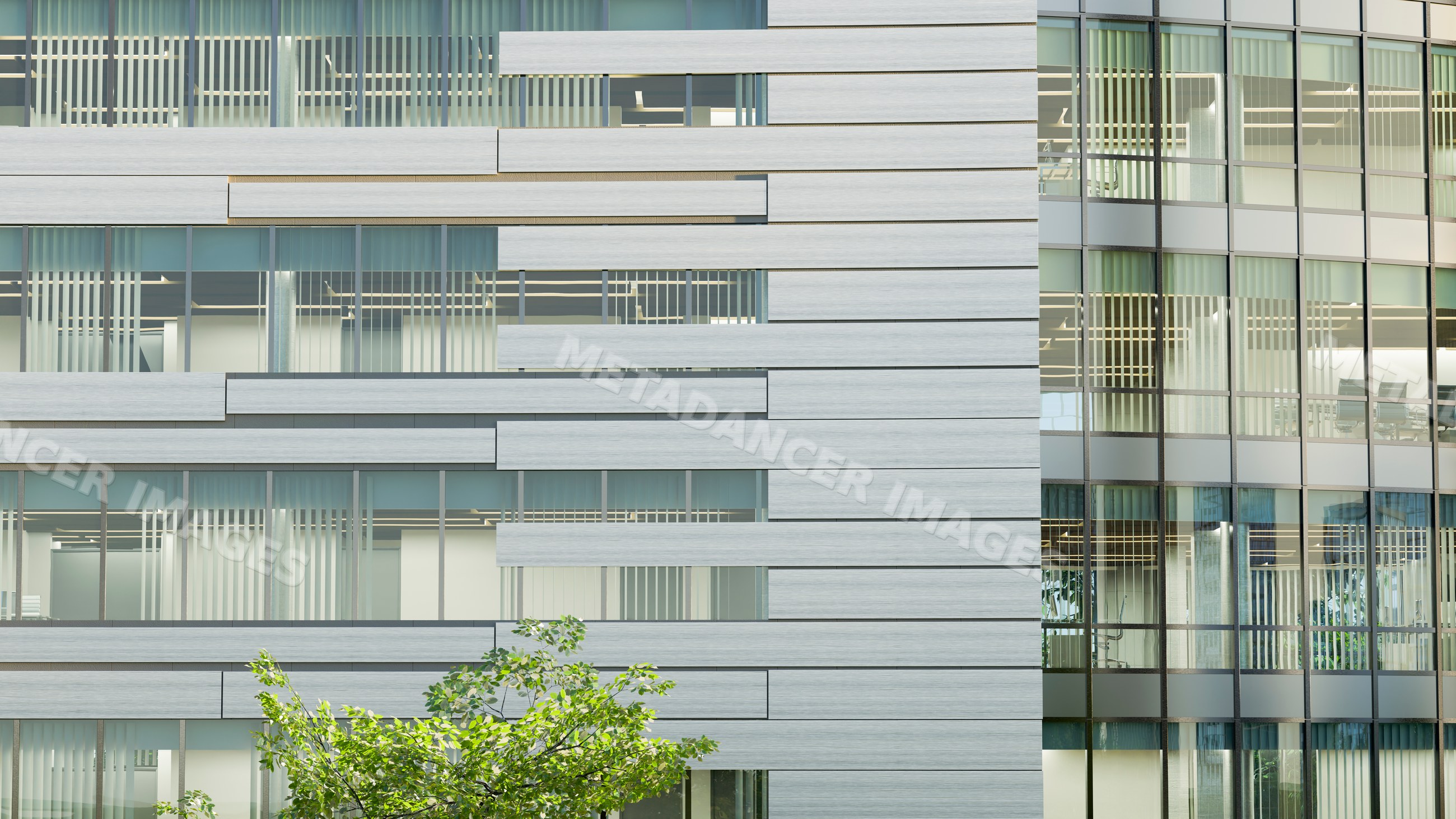 Modern office building exterior with glass windows and steel panels