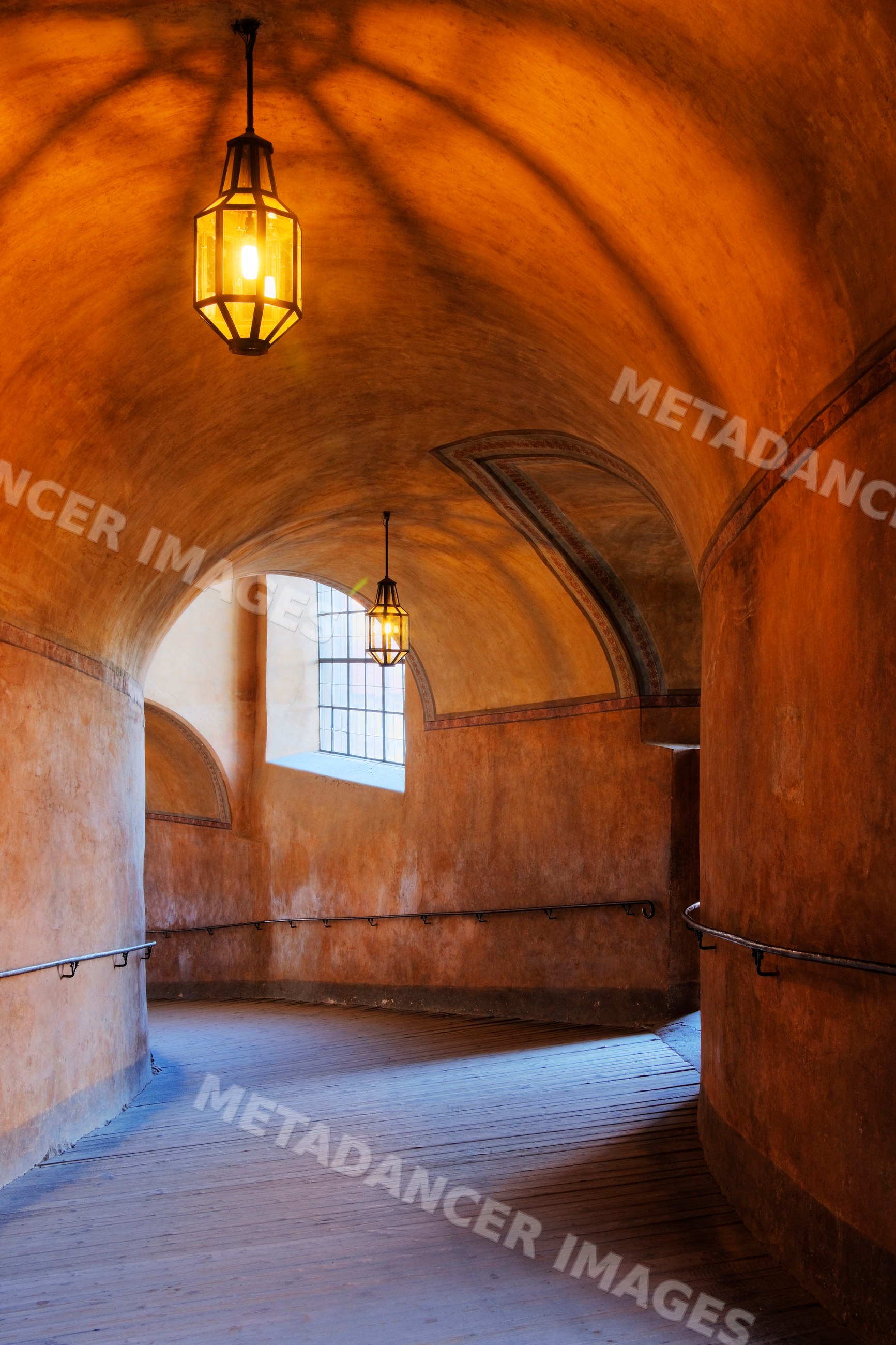 Curved arched hallway with wooden floor inside cesky krumlov castle