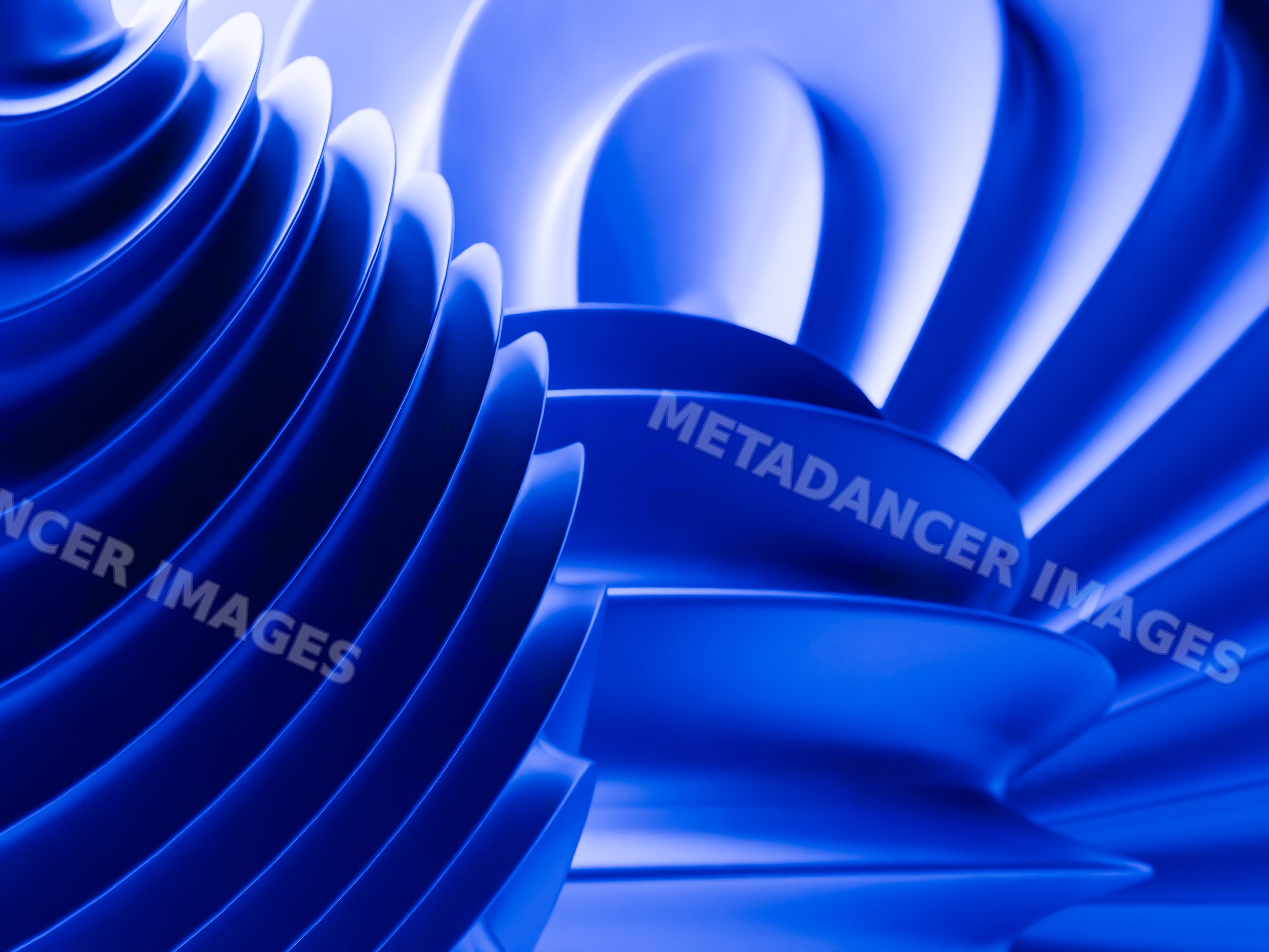 A close-up view of blue abstract curved shapes with layered textures