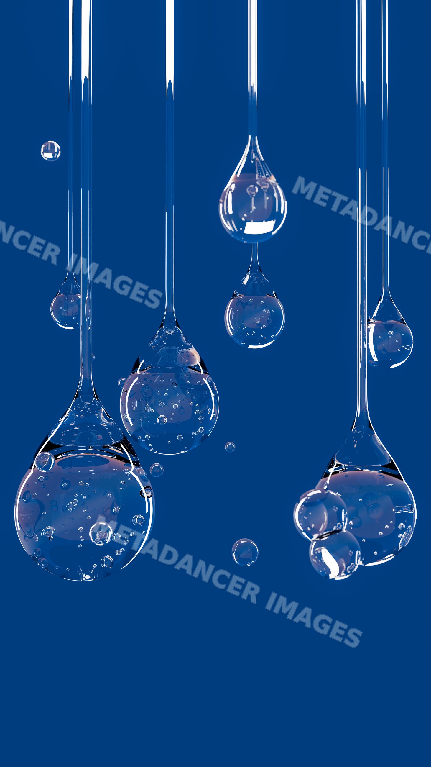 Transparent liquid drops with bubbles suspended against blue