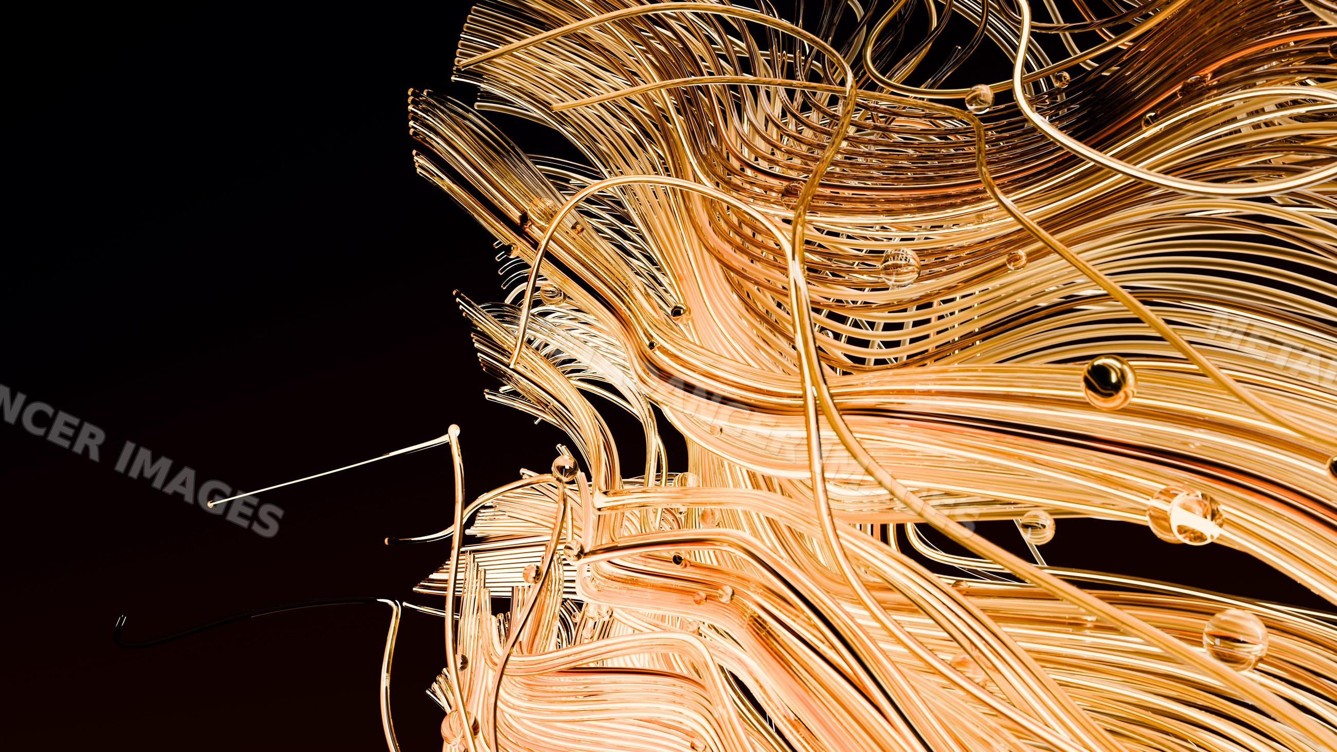 Abstract glass sculpture with golden curved tubes and flowing shapes